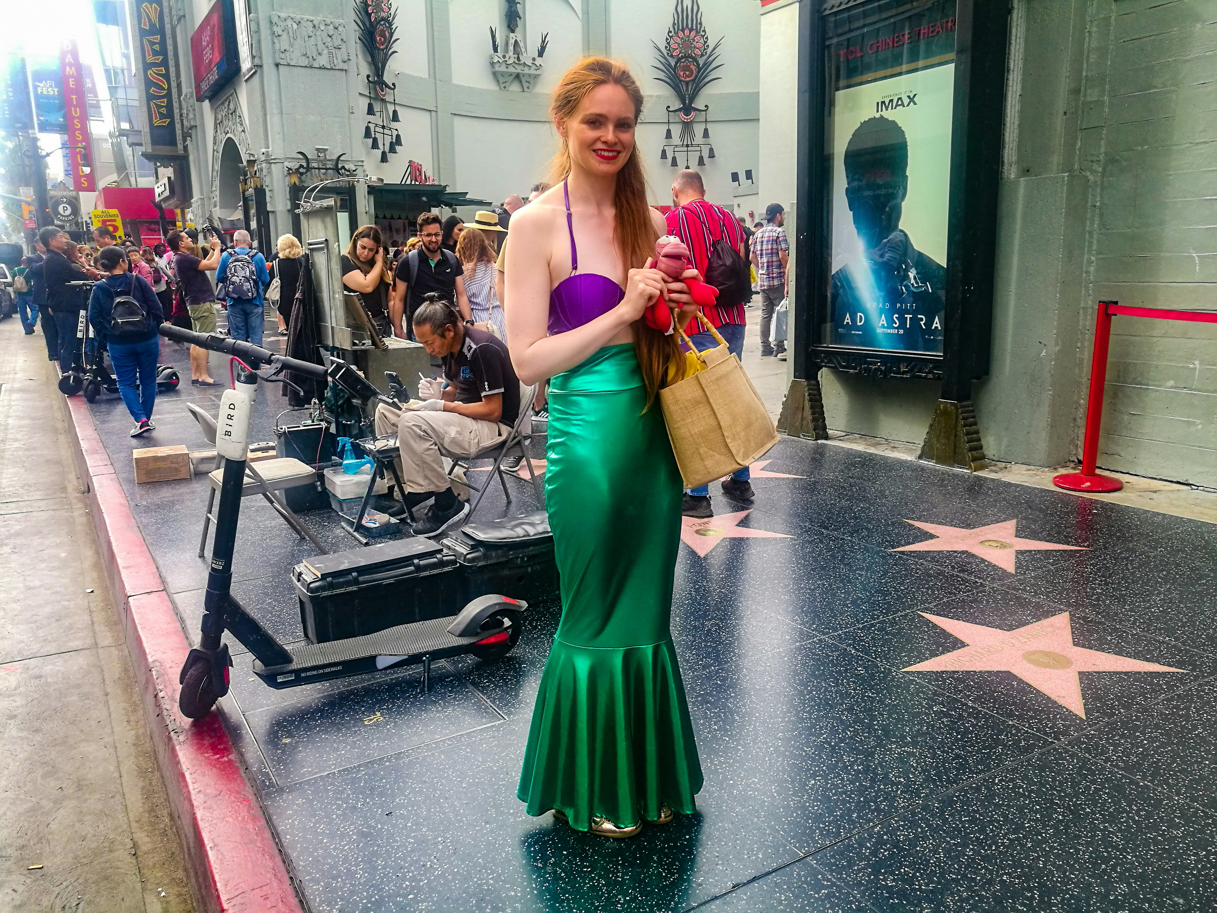 Ariel the Little Mermaid stands on the Hollywood Walk of Fame