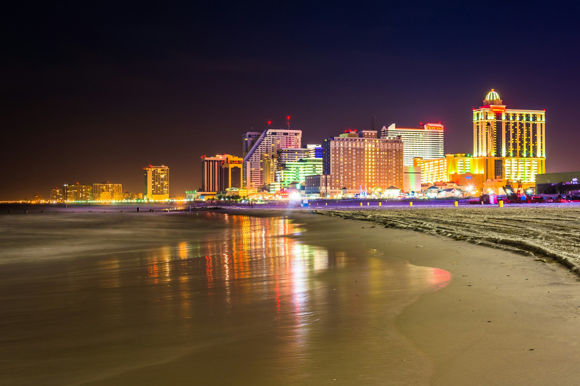 The skyline and Atlantic Ocean at night in Atlantic City, New Jersey.