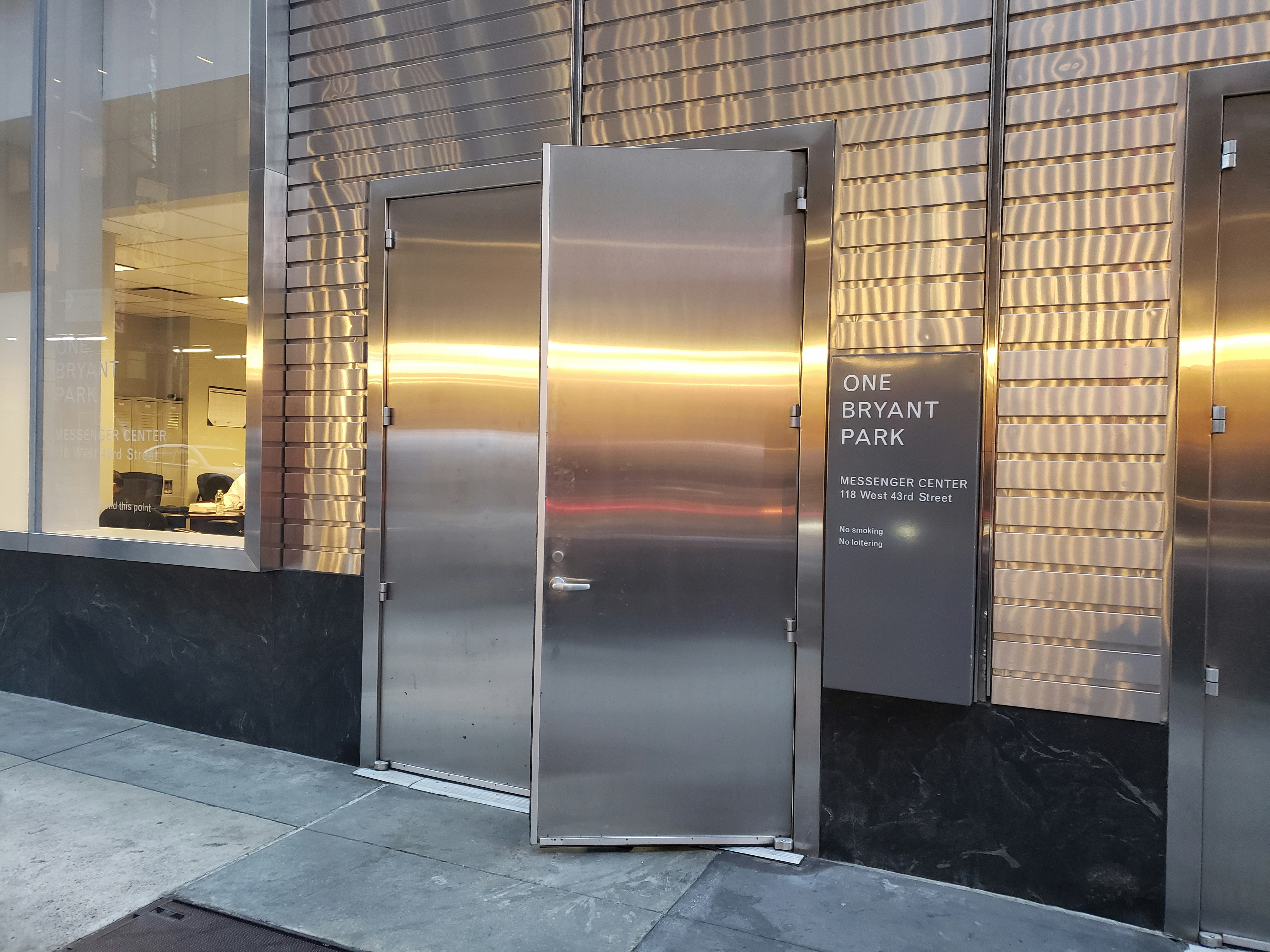 The silver metal clad facade of the Bank of America Tower service entrances, which have a different address than the hotel itself.