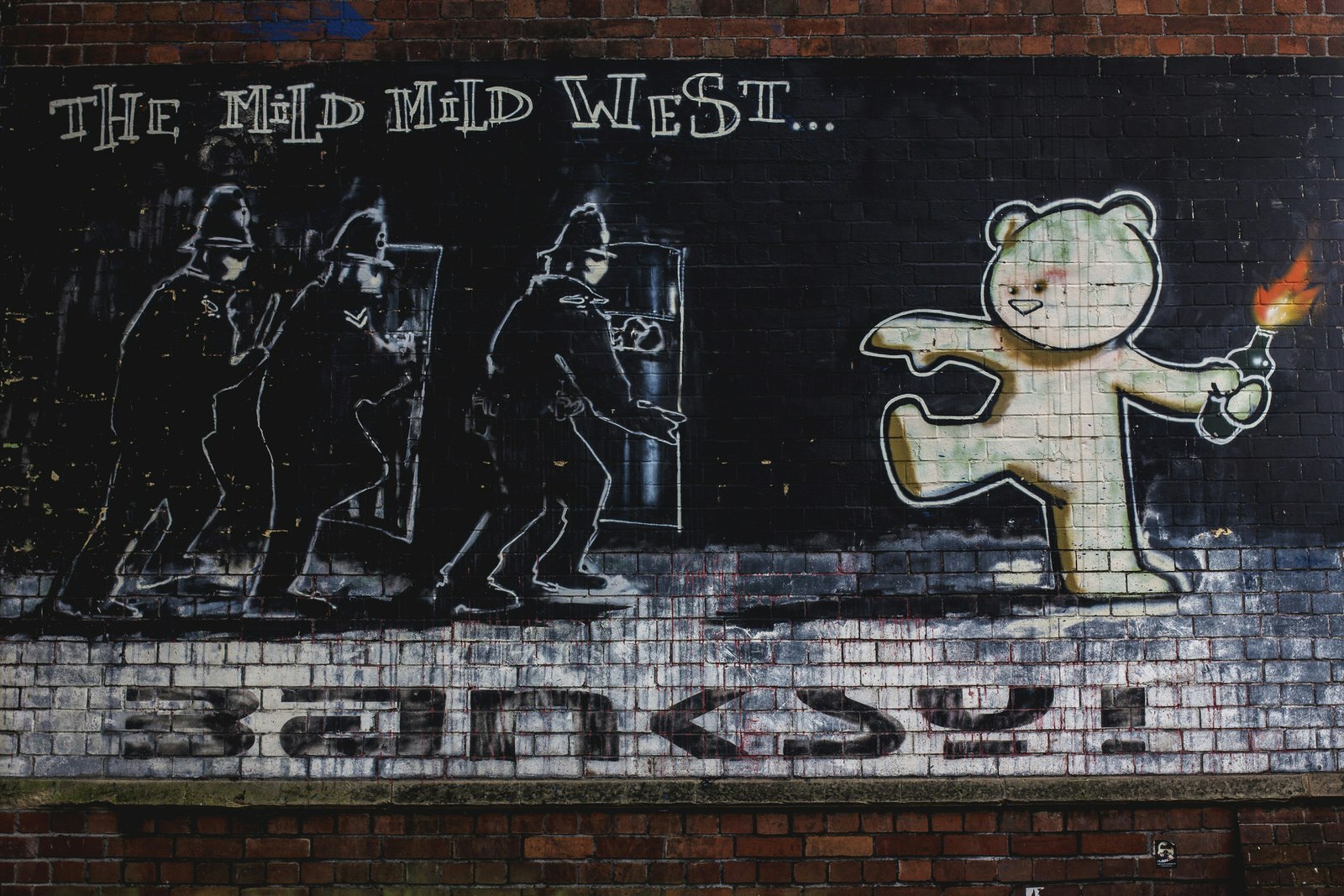 Banksy's 'Mild Mild West' mural in Bristol showing a cartoon bear throwing a petrol bomb at three riot police