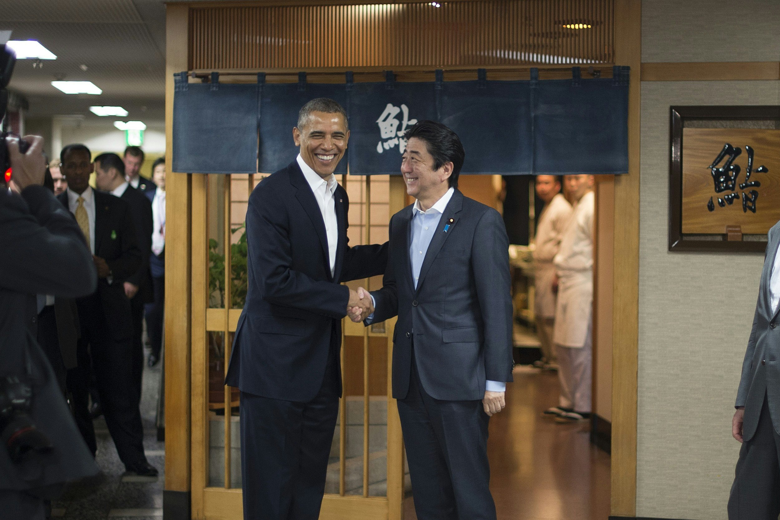 Barack Obama and Japanese prime minister Japanese outside a Japanese sushi restaurant