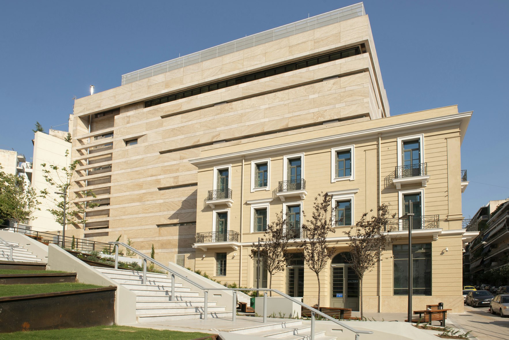 An exterior image of a large modern building with sandstone-coloured brickwork