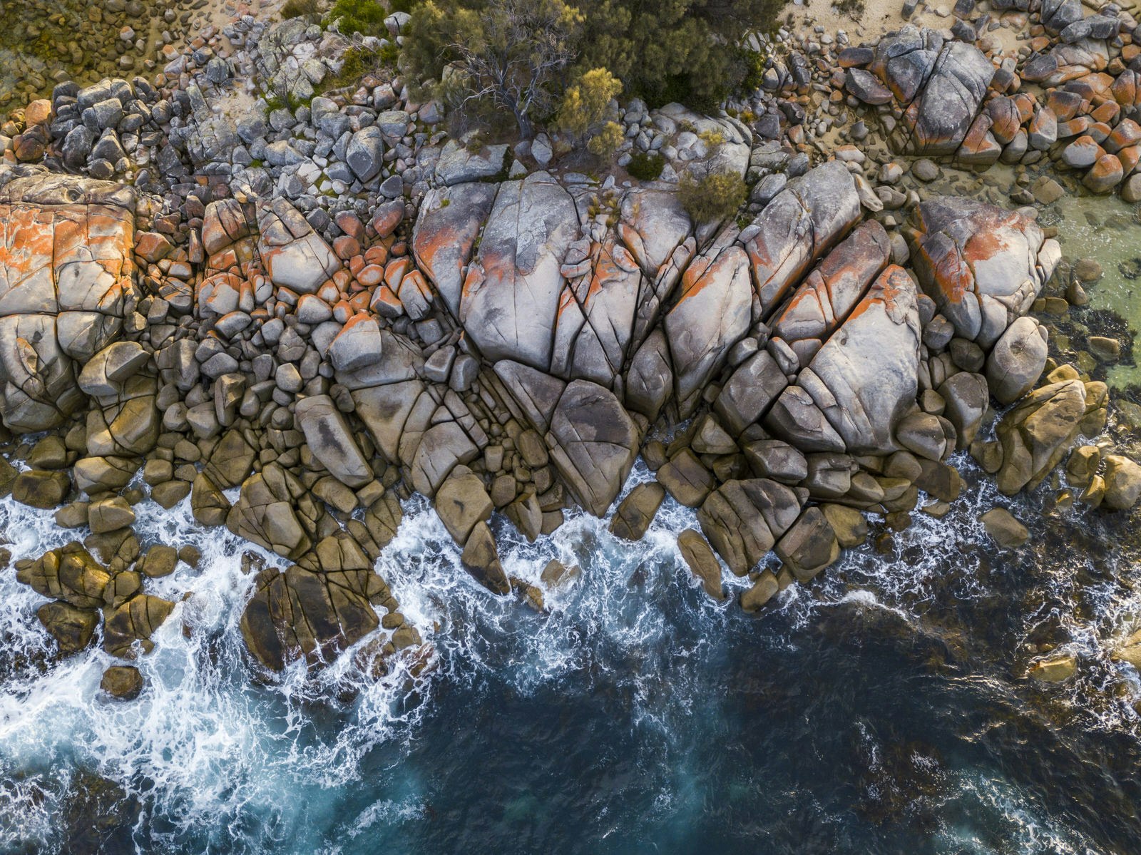 Aerial of a rocky section in the Bay of Fires on the East Coast of Tasmania.