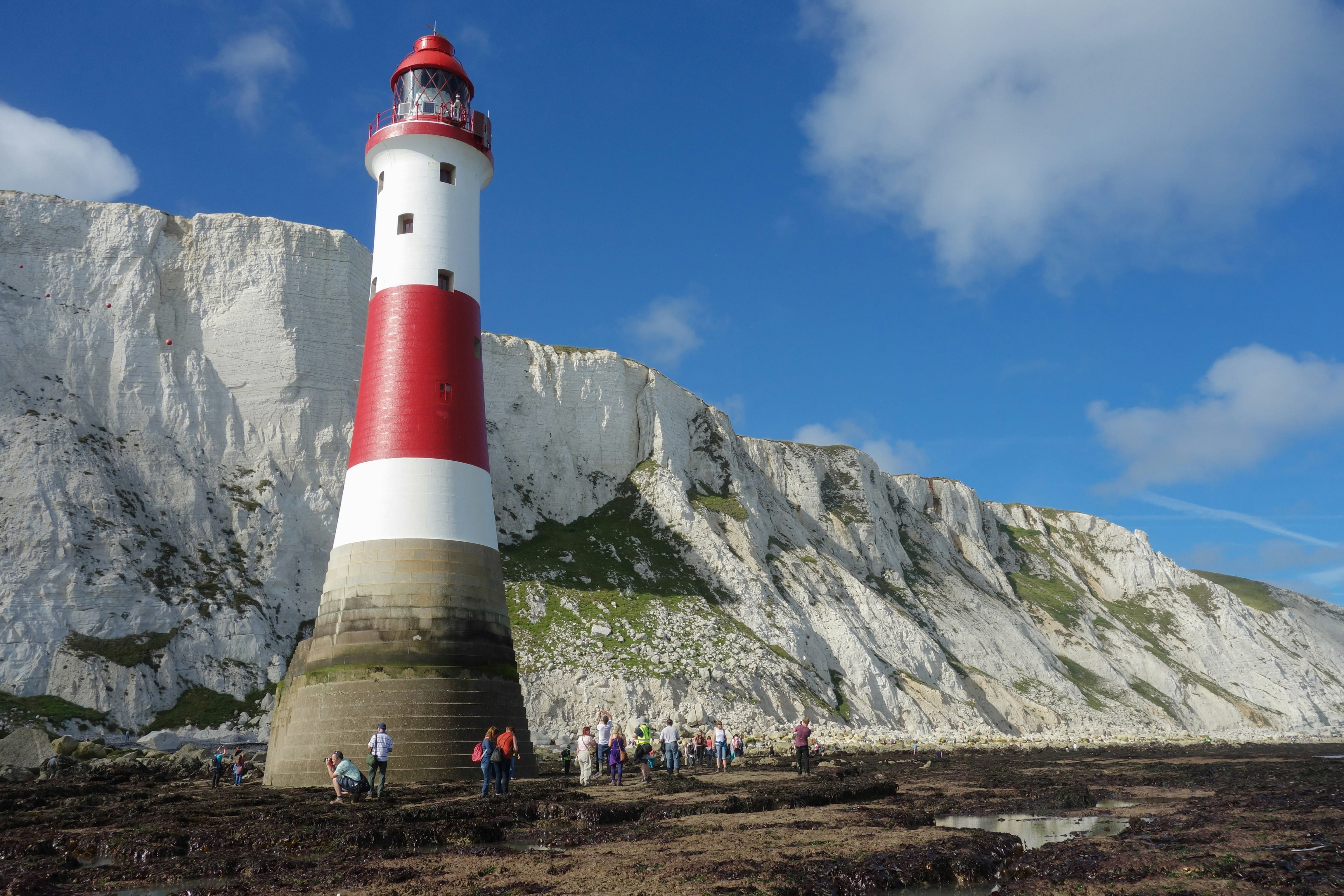 People on Beachy Head Lighthouse walk challenge during low tide