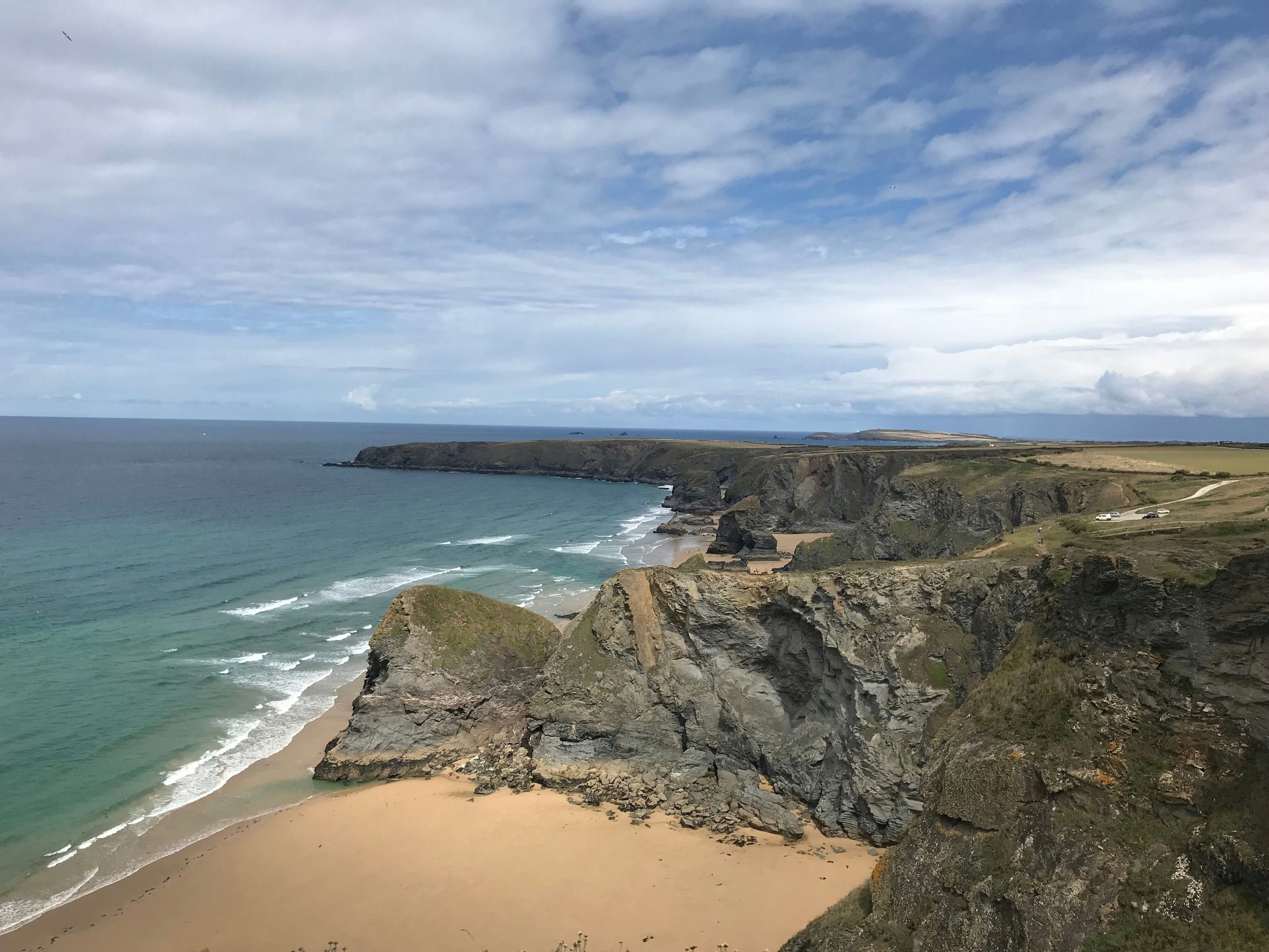 Dramatic cliffs over a golden sand beach.