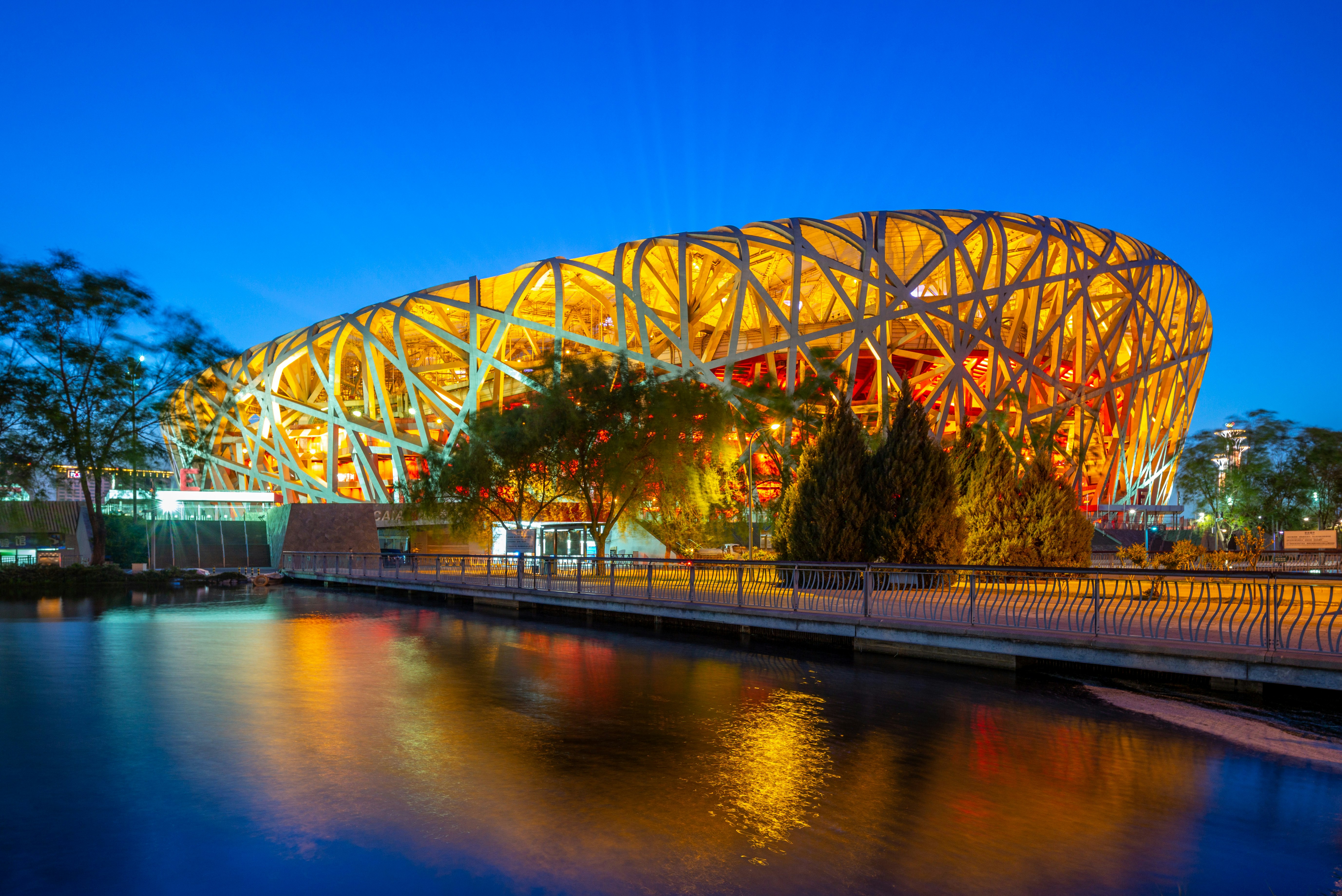 The Beijing National Stadium is illuminated at night.  