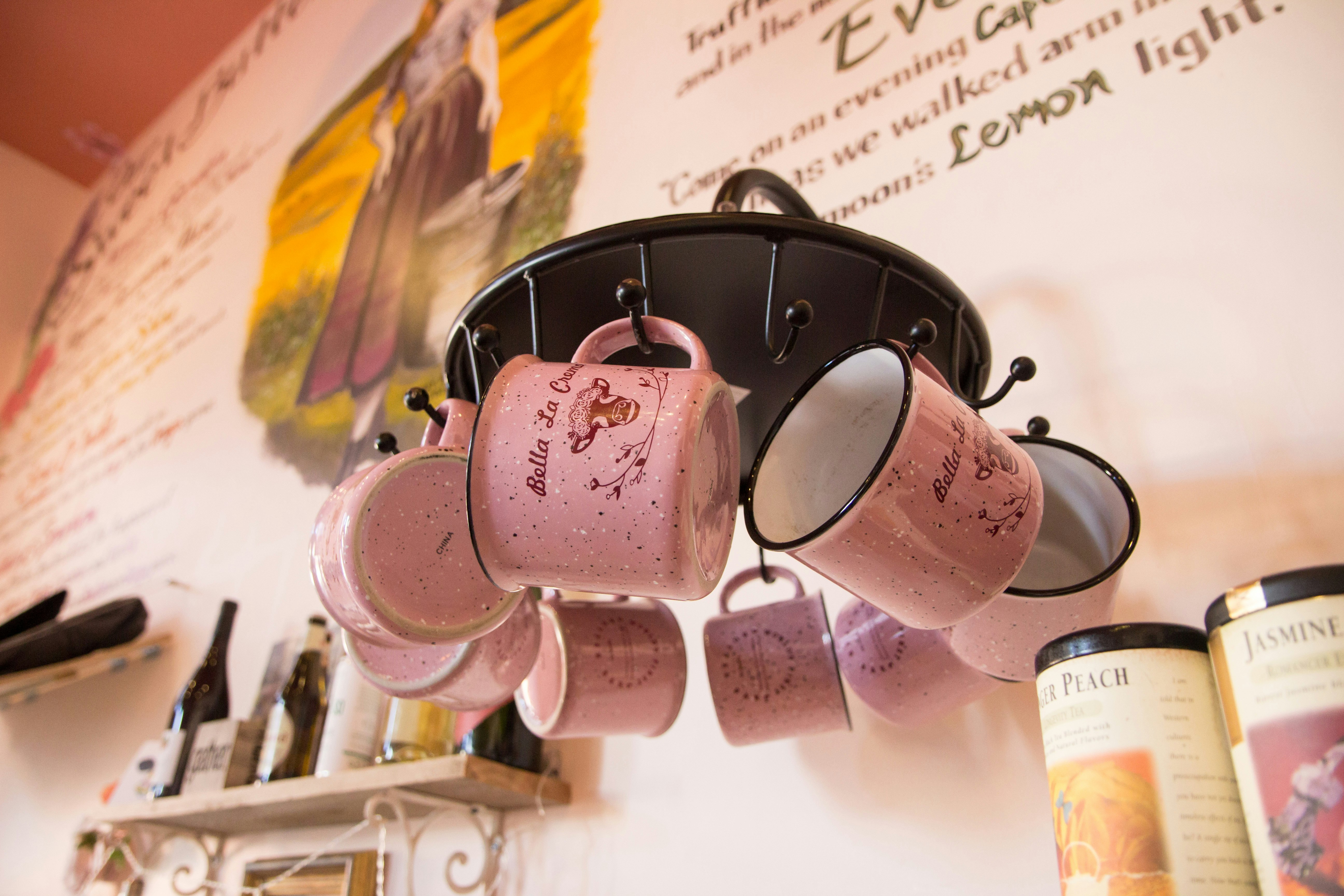 A rack of pink Bella la Crema mugs with the butter menu in the background