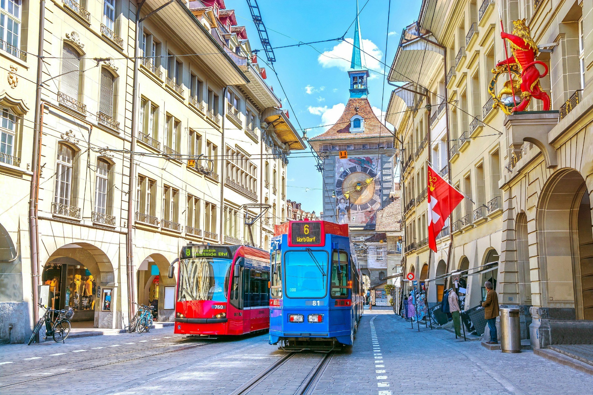 Trams outside the Zytglogge astronomical clock tower in the historic old medieval city center of Bern