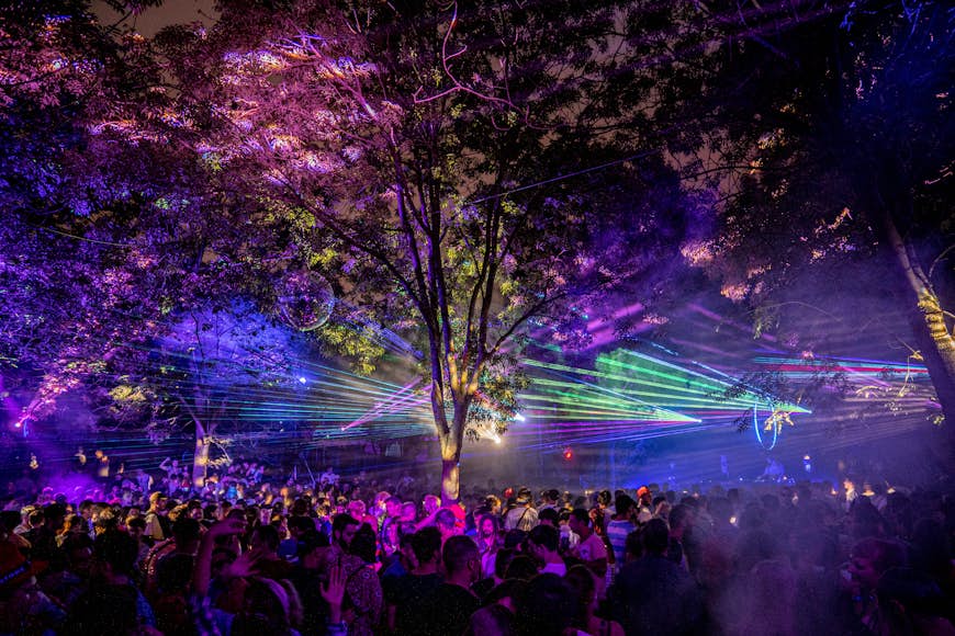 A laser light show takes place over the heads of a crowd dancing to a night-time electronic music set at Bilbao BKK Live festival.