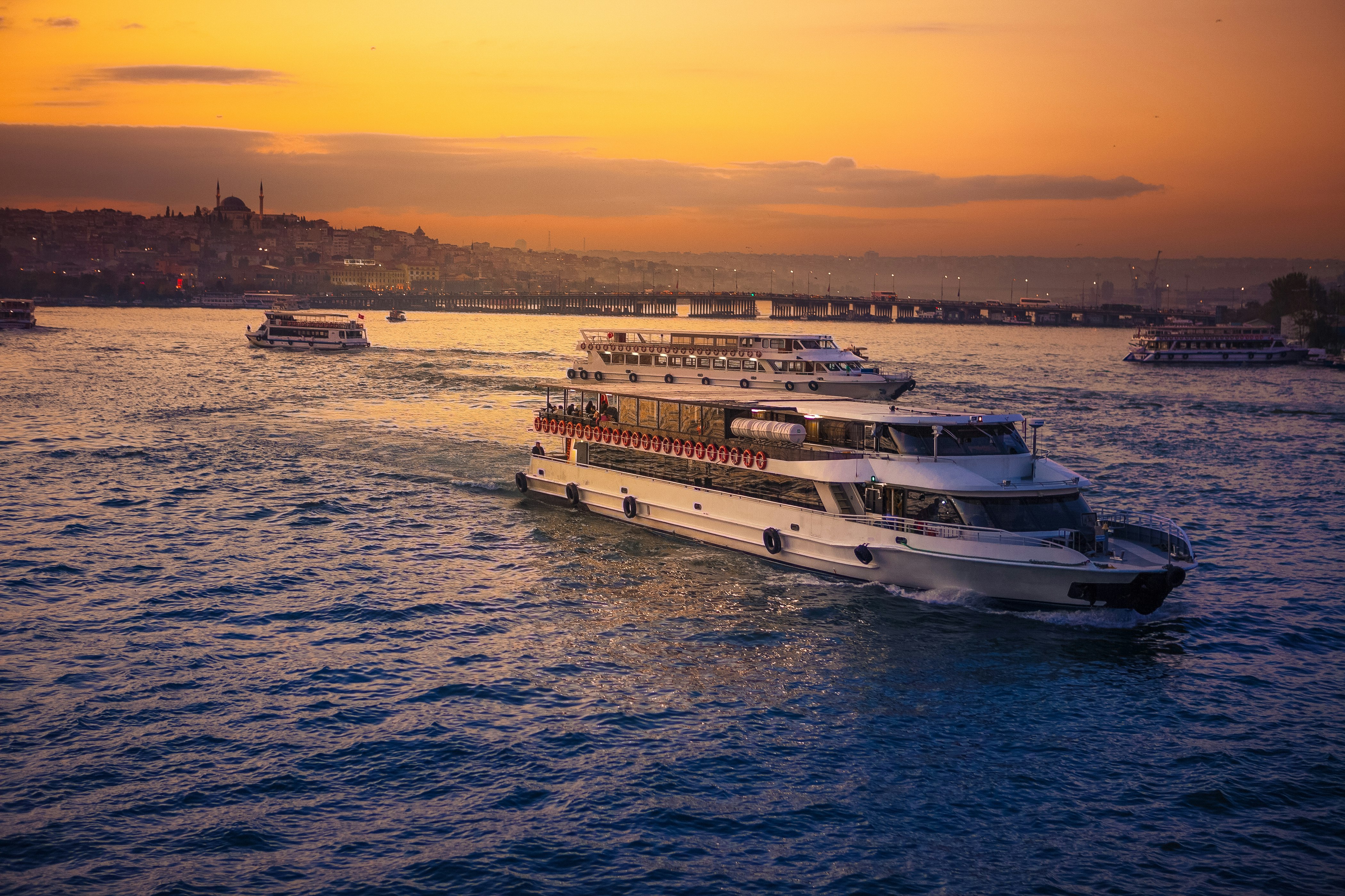 Boats motor along the Bosphorus in Turkey with the Istanbul skyline in the background