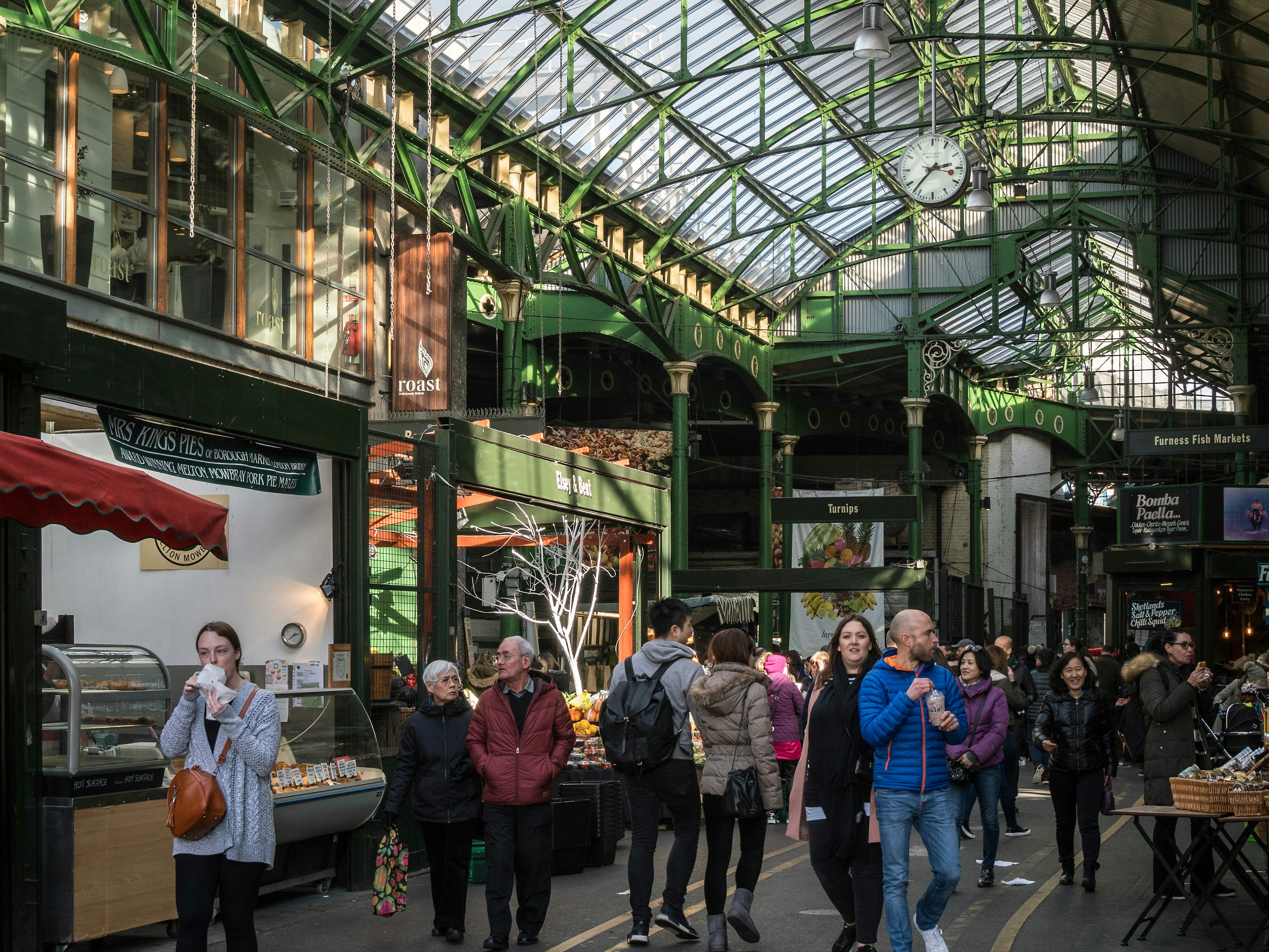 People exploring the covered Borough Food Market in London