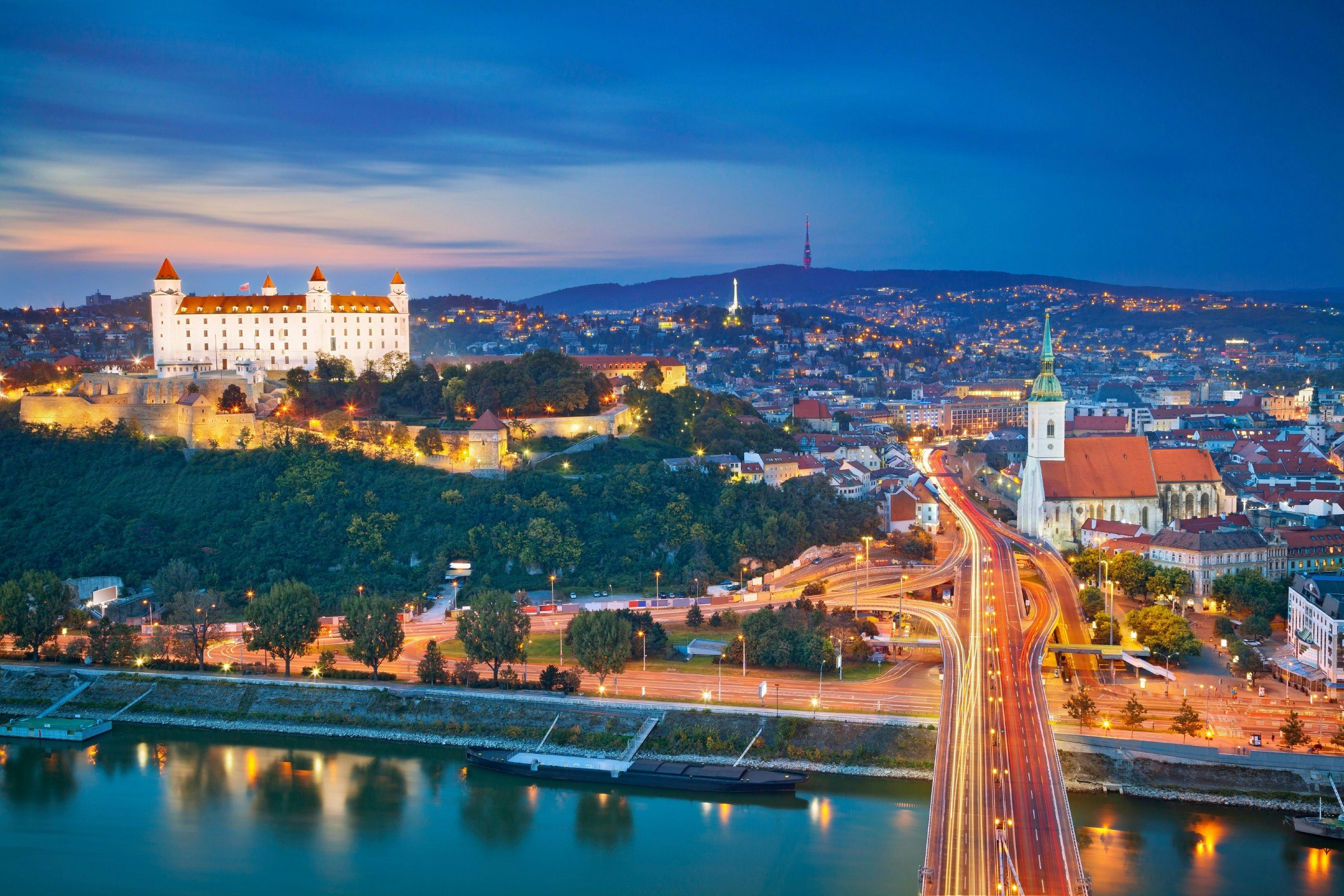 Bratislava's illuminated cityscape at dusk, 