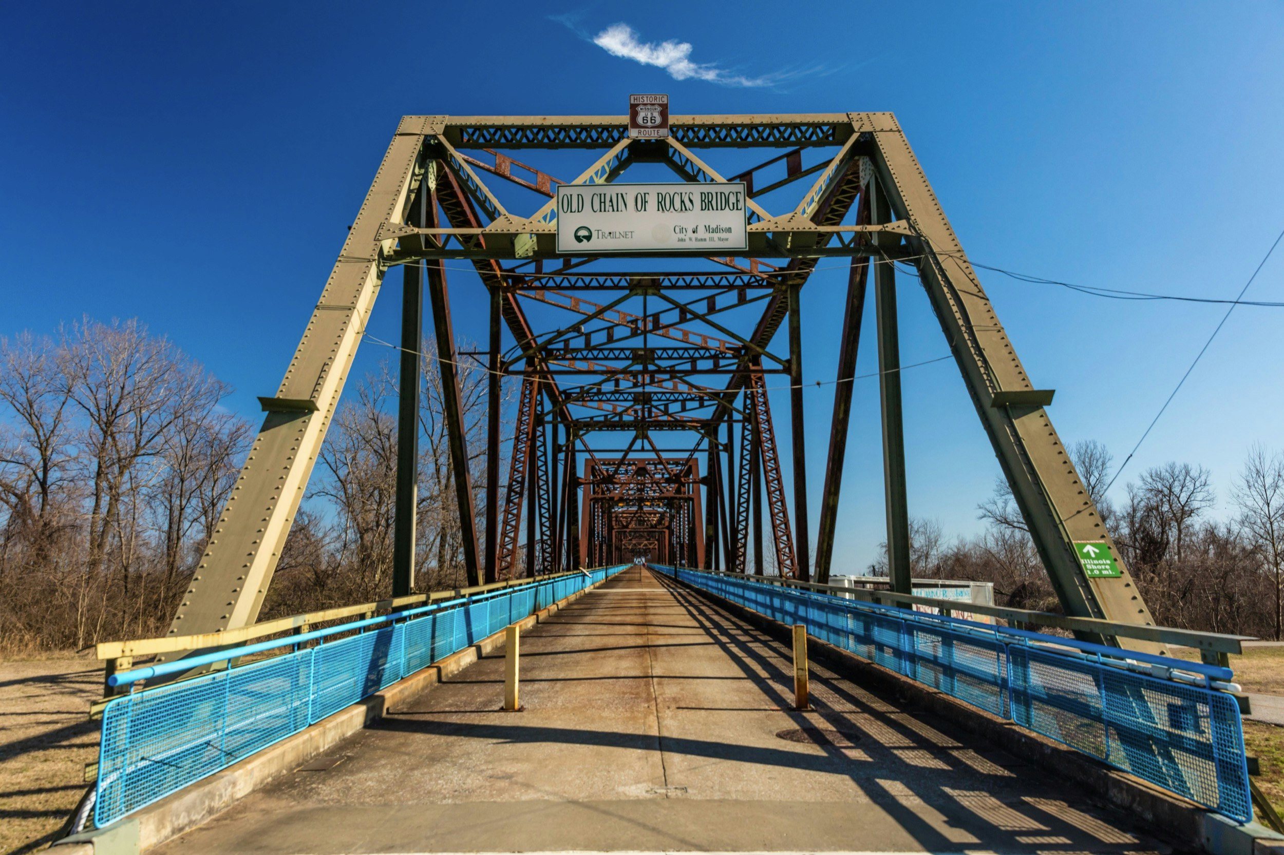 A rust-covered suspension bridge crosses the Mississippi River with a pedestrians-only roadway running through it; Off the beaten path sights in St Louis