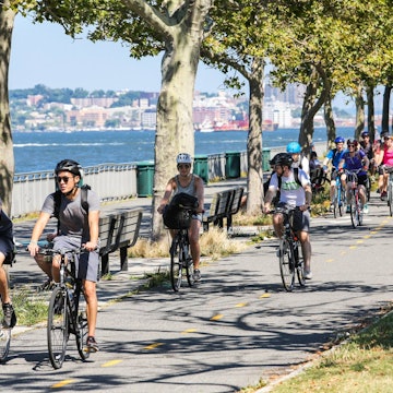 A line of cyclists on the Brooklyn waterfront