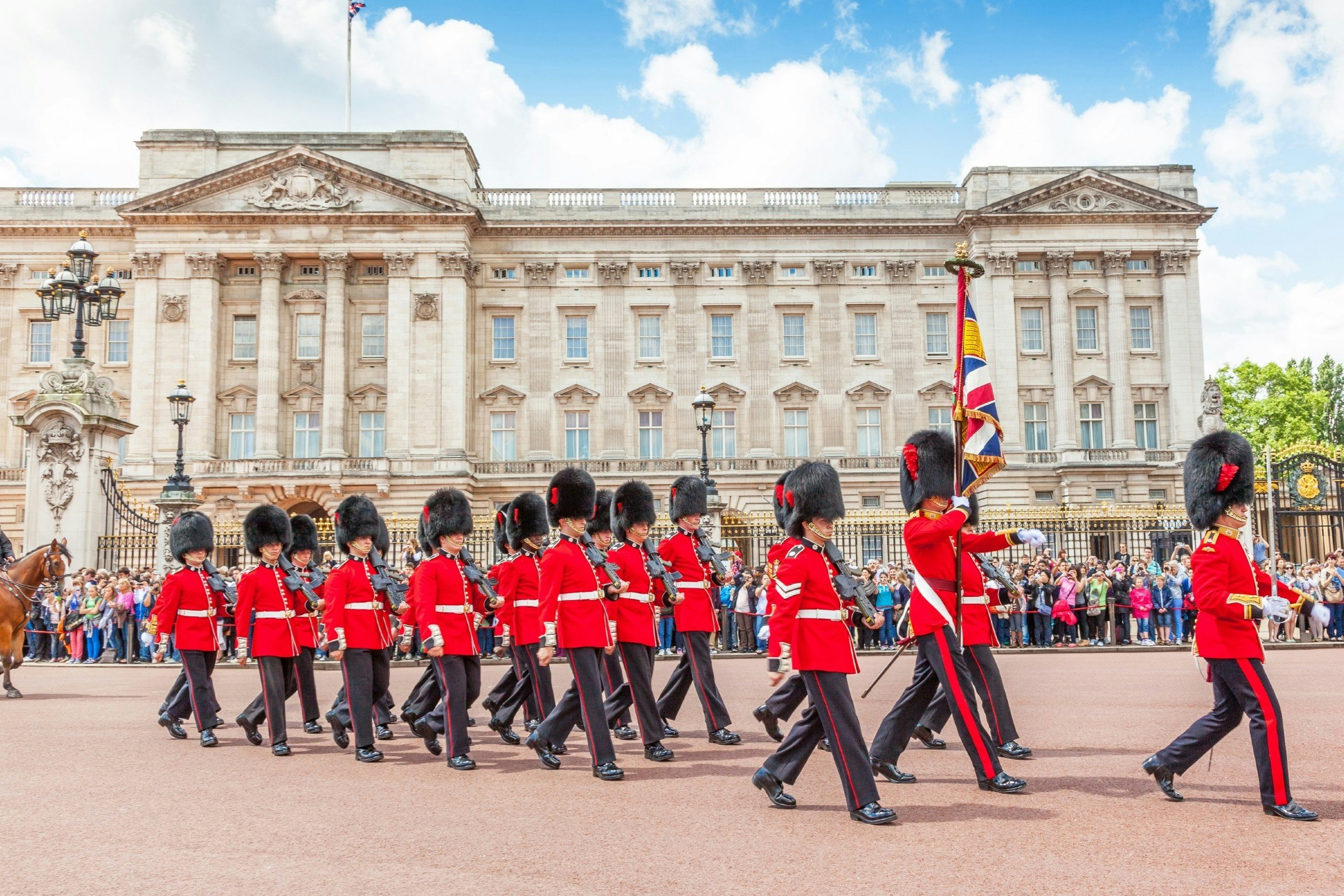 Officers and soldiers of the Coldstream Guards march in front of Buckingham Palace during the Changing of the Guard ceremony