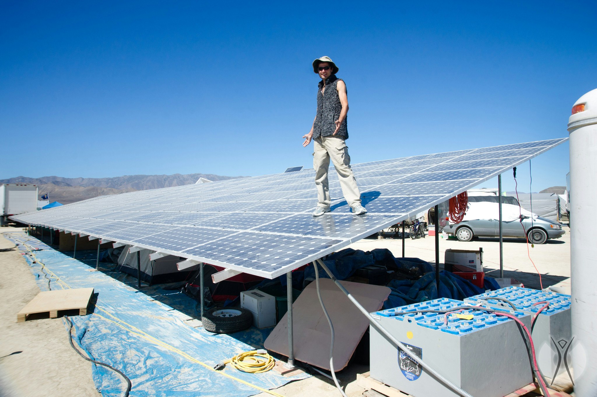 A man stands on solar panels in Black Rock City. 