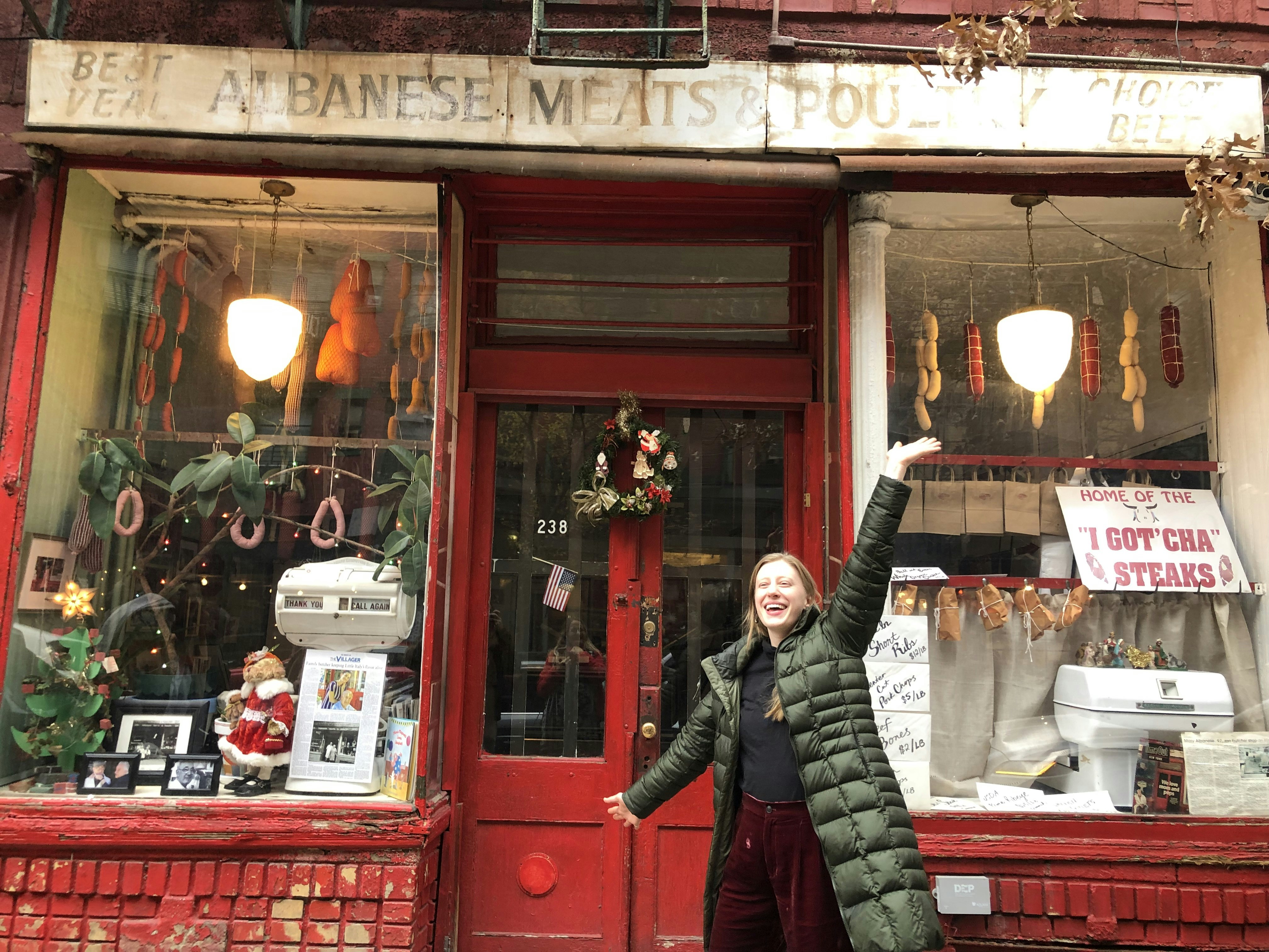A woman outside of the butcher shop where Midge and her mother shop, a stop on Mrs. Maisel's Marvelous Tour of New York City
