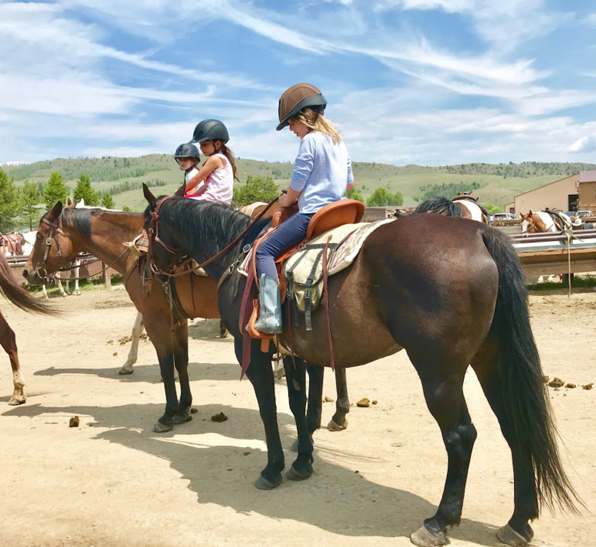 Kids sit on horses as they receive instruction about how to handle the animals at C Lazy U vacation guest dude ranch