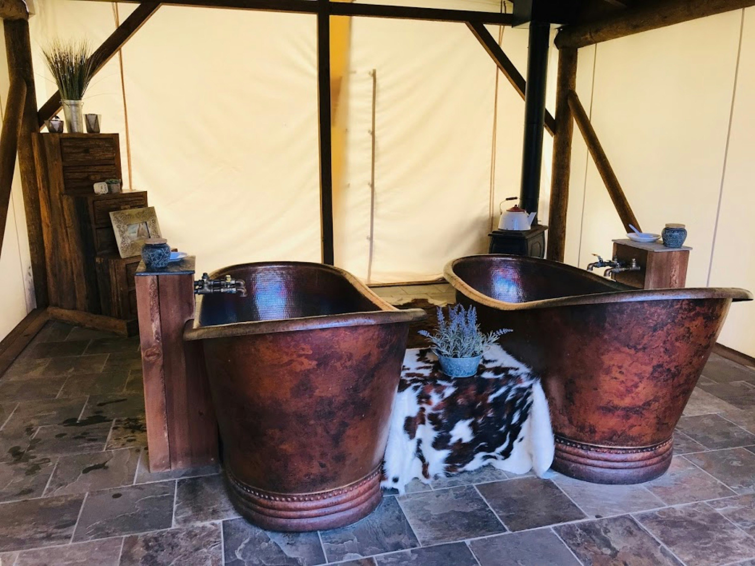 A pair of copper bathtubs are side-by-side in a canvassed-walled tent at the C Lazy U ranch's spa, called Lazy You.