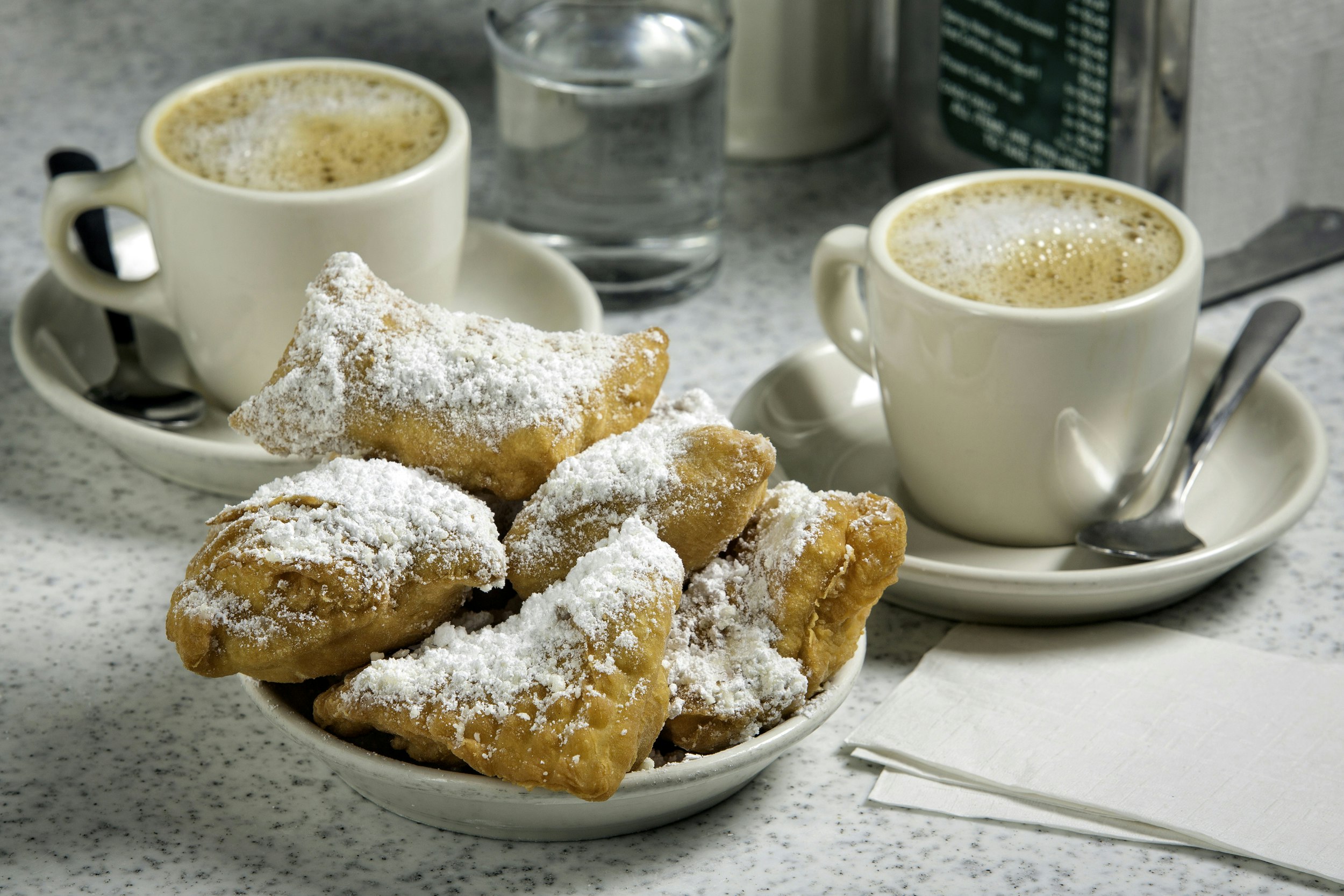 A plate of beignets with coffee