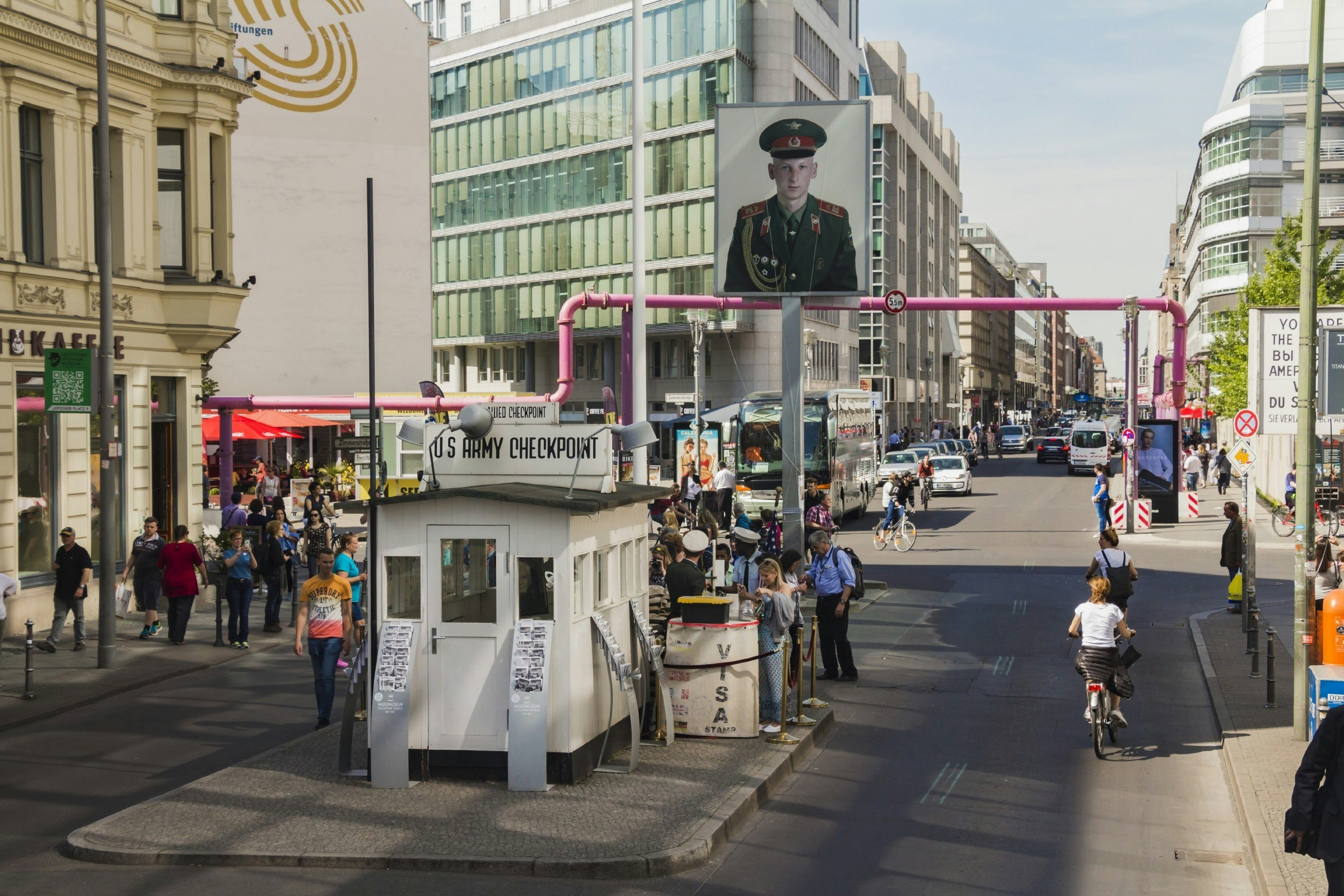 A crowd of people at Checkpoint Charlie, the former Berlin Wall border crossing point between East and West Berlin.