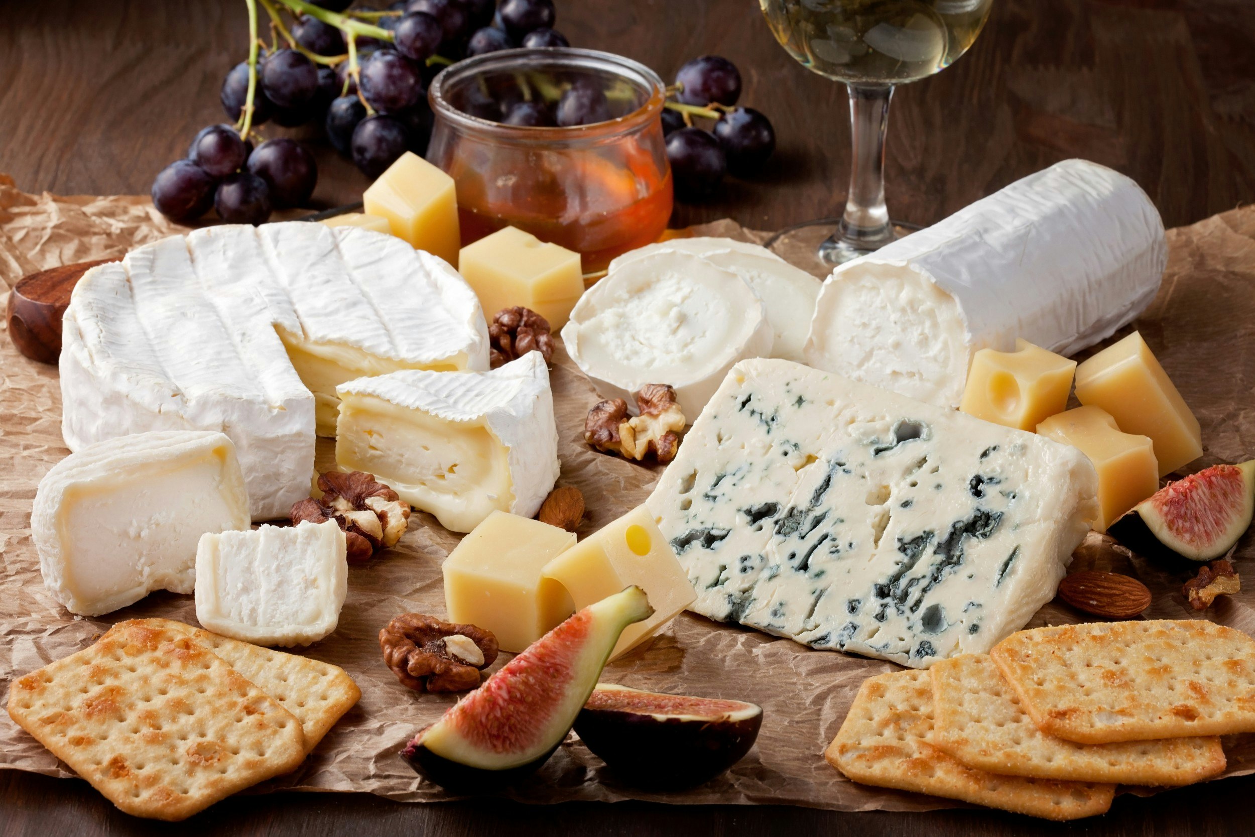 A cheese board filled with cheese and fruit