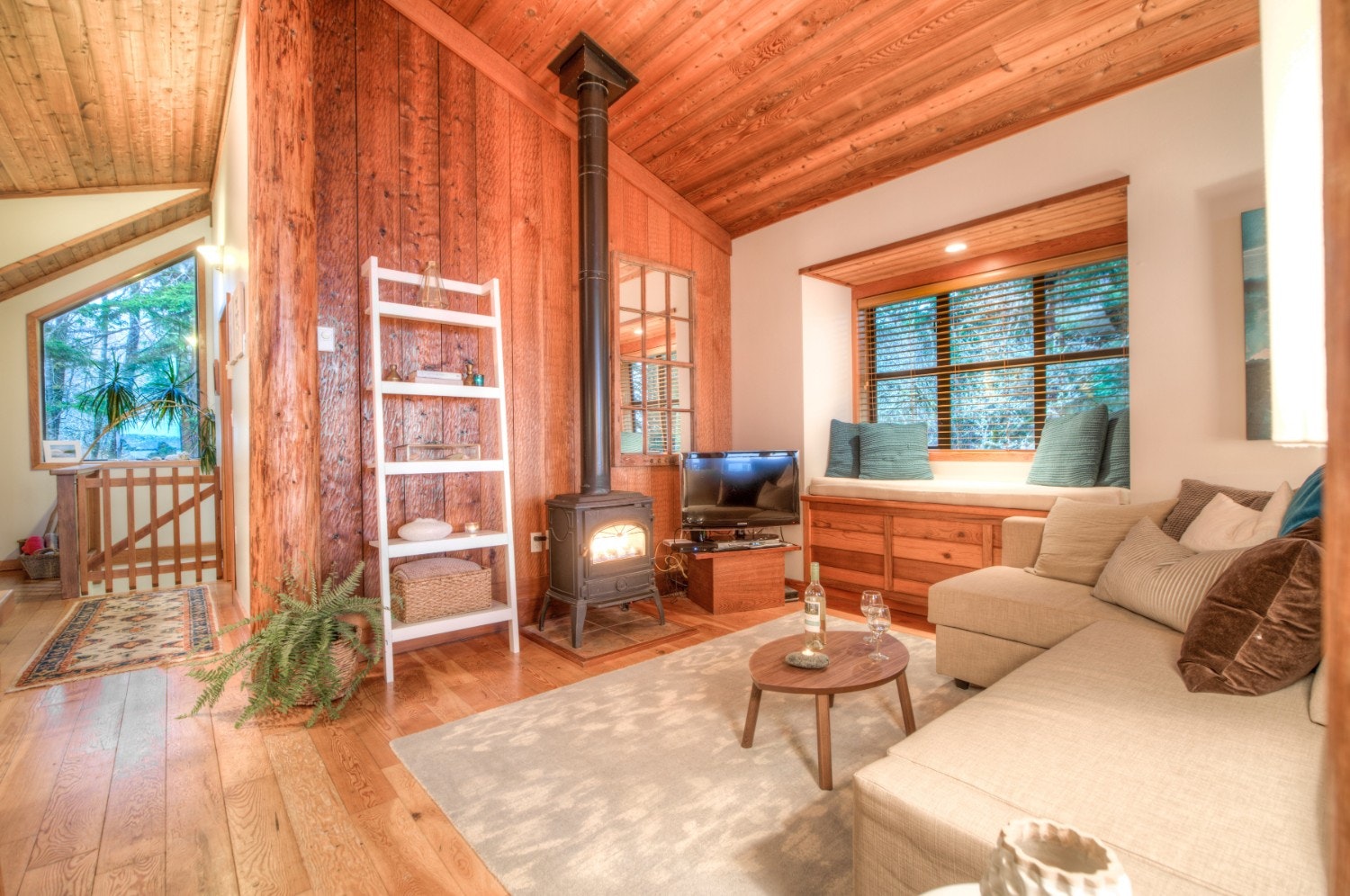 A wooden panelled living room in a forest