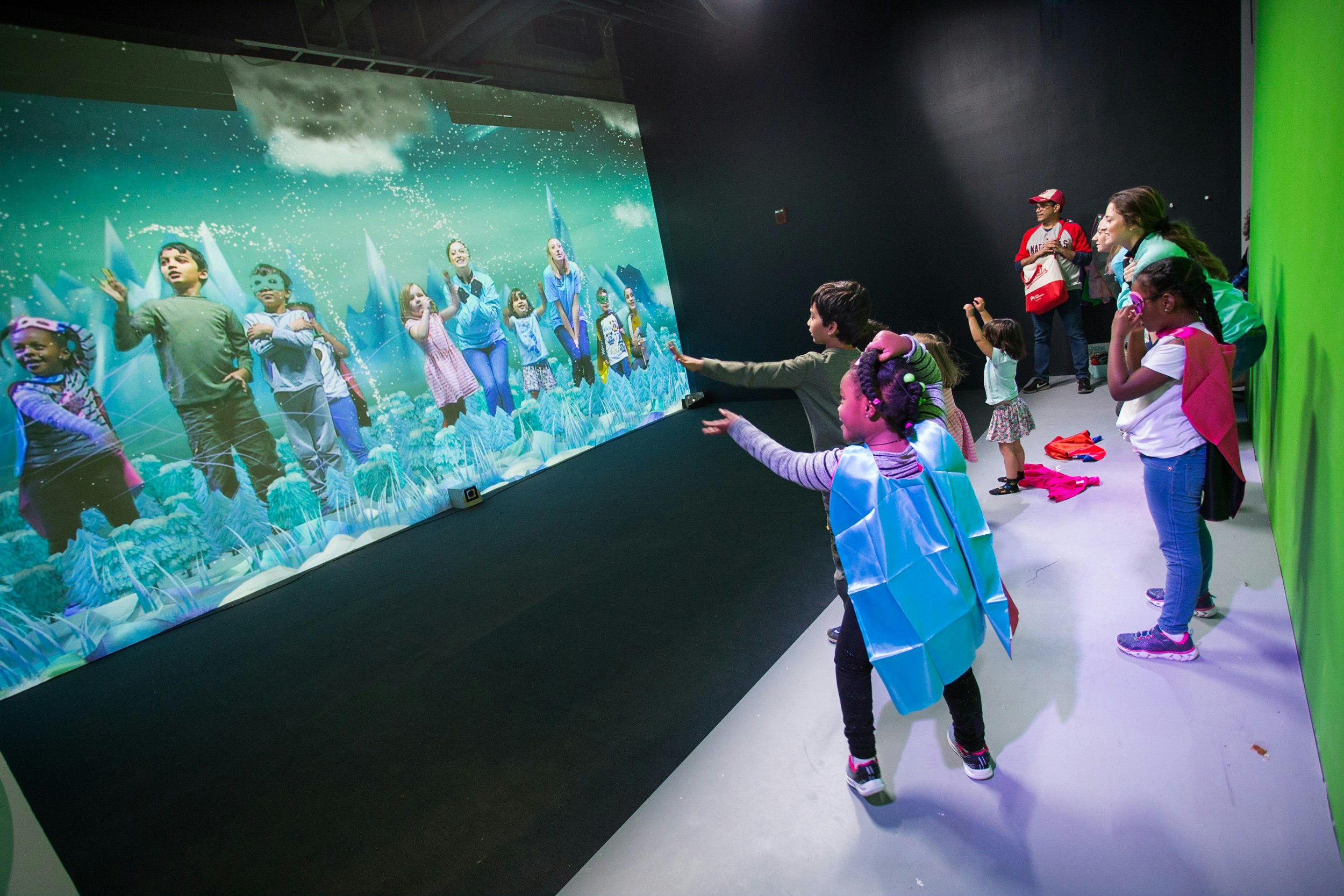 Group of children interact with a large screen.jpg