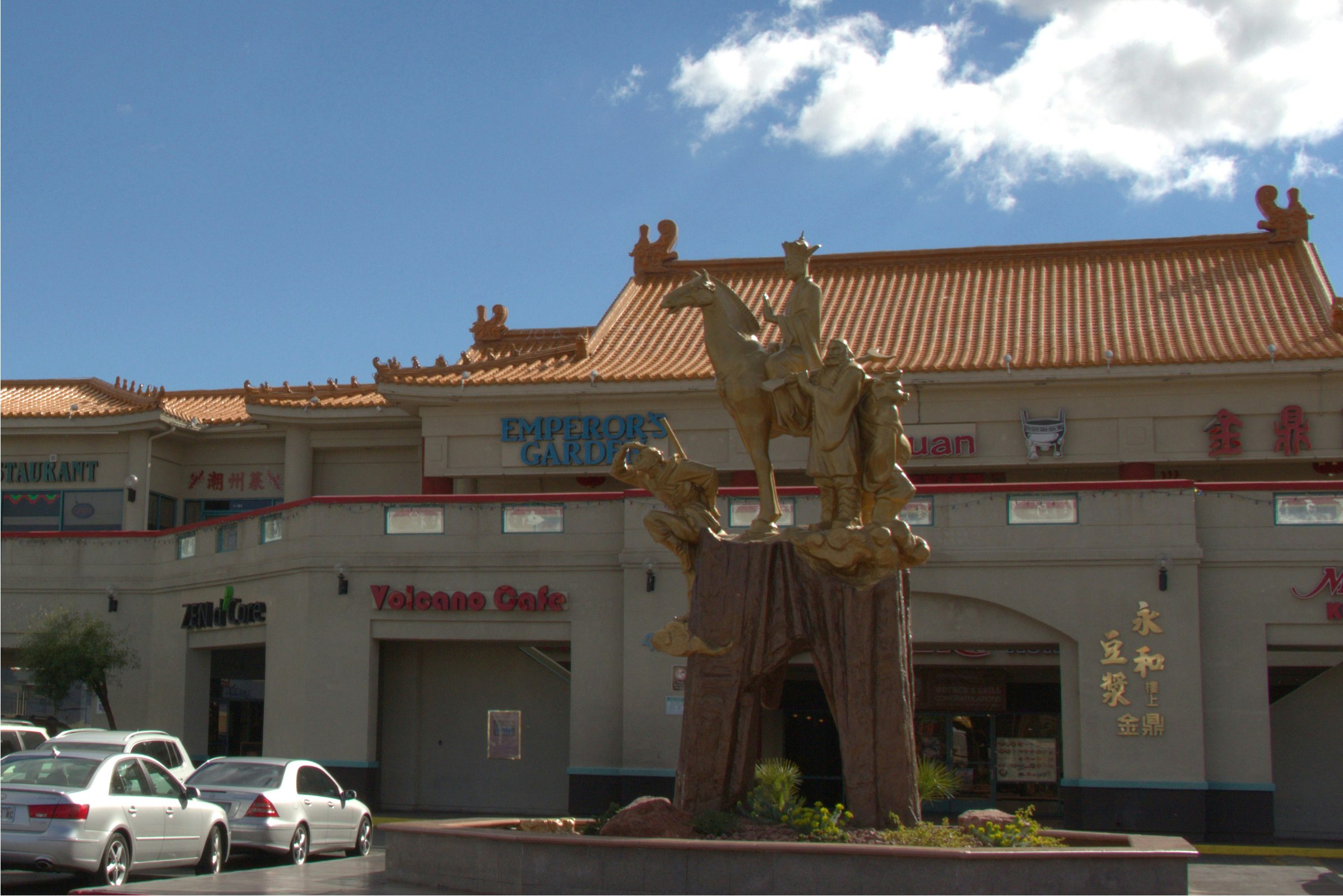 Gold statue depicting the 'Journey to the West' of Xuan Zang and the Monkey God overlooking Chinatown Plaza