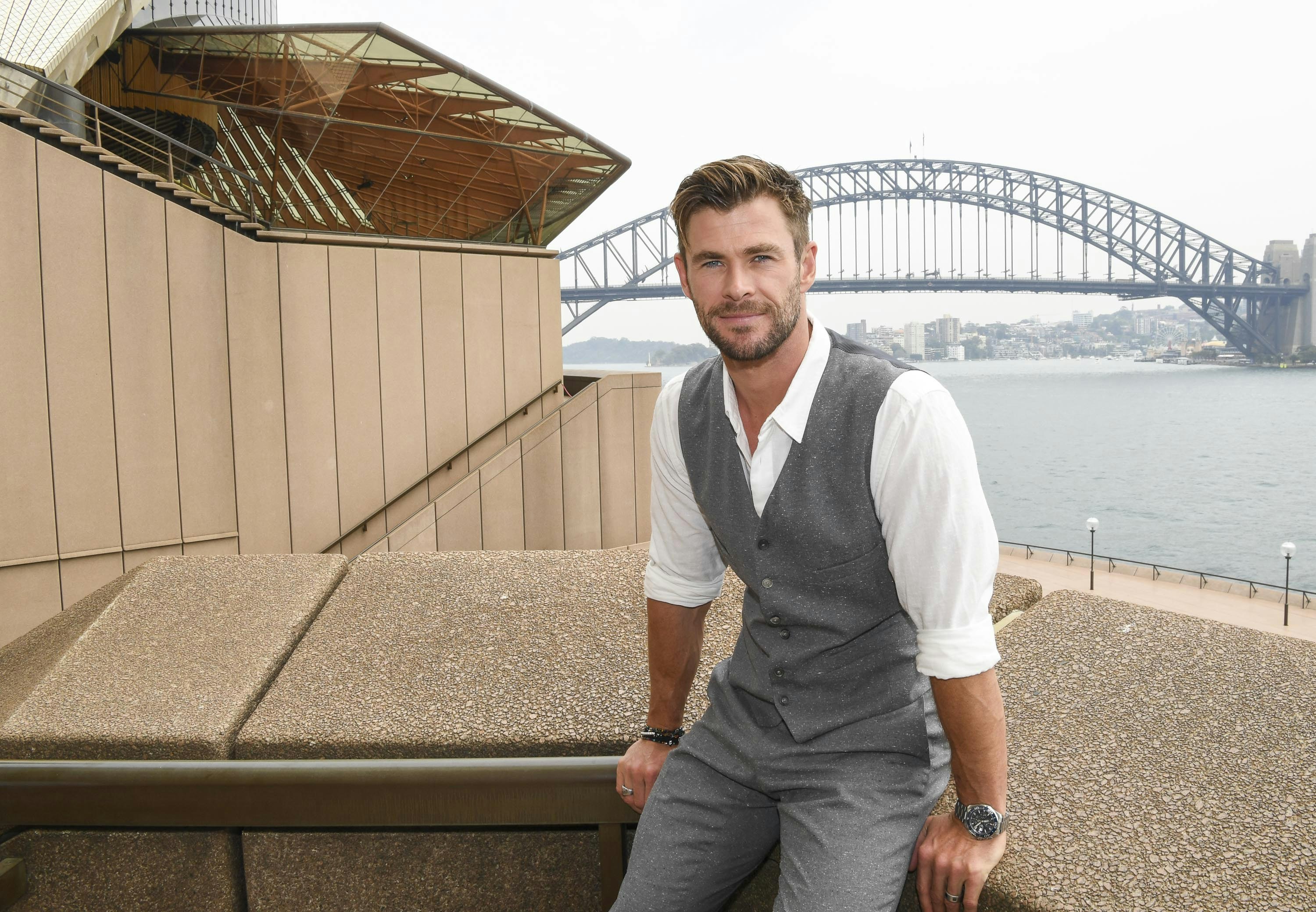Chris Hemsworth sitting next to Sydney Harbour.jpg