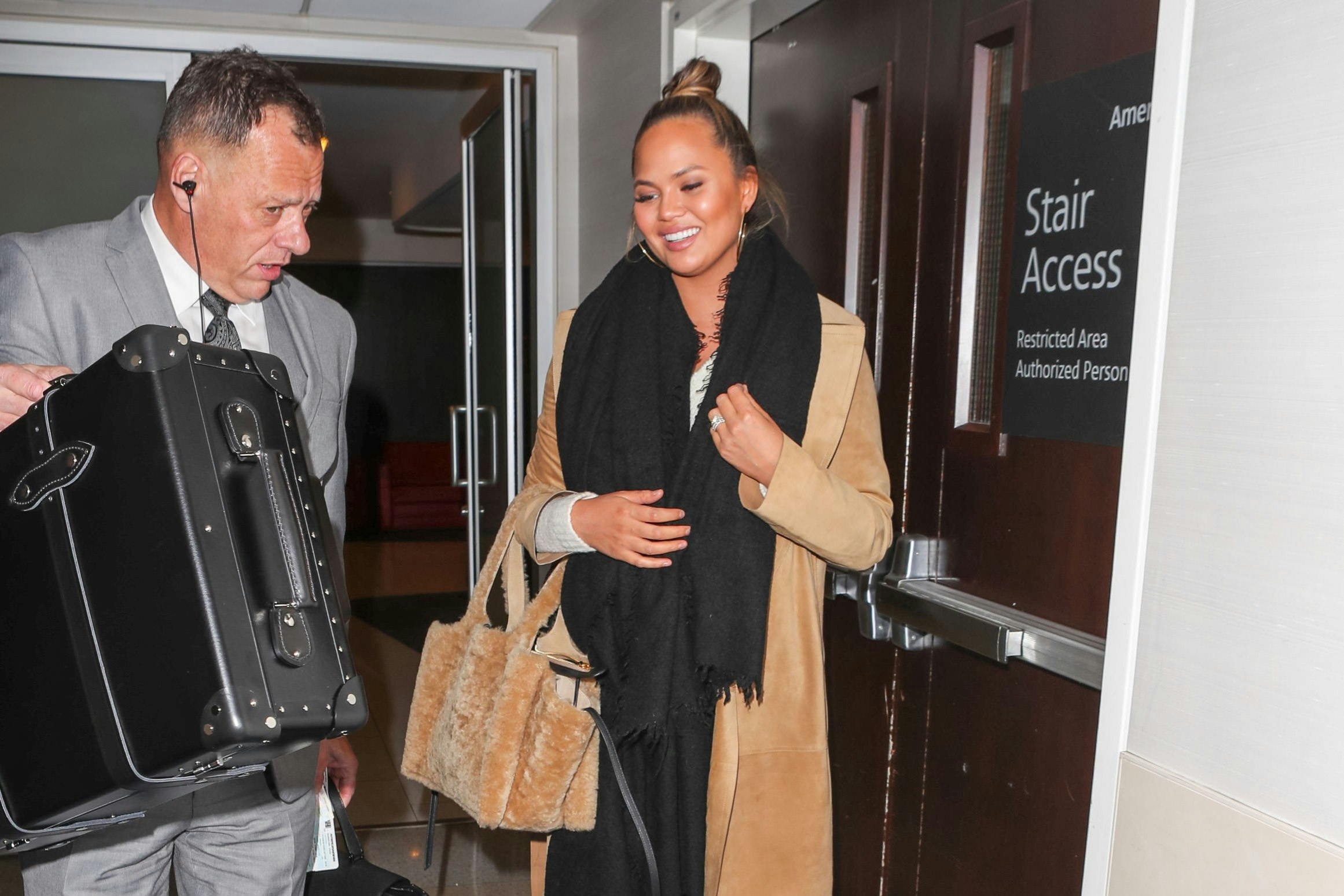 Chrissy Teigen and a security guard at LAX