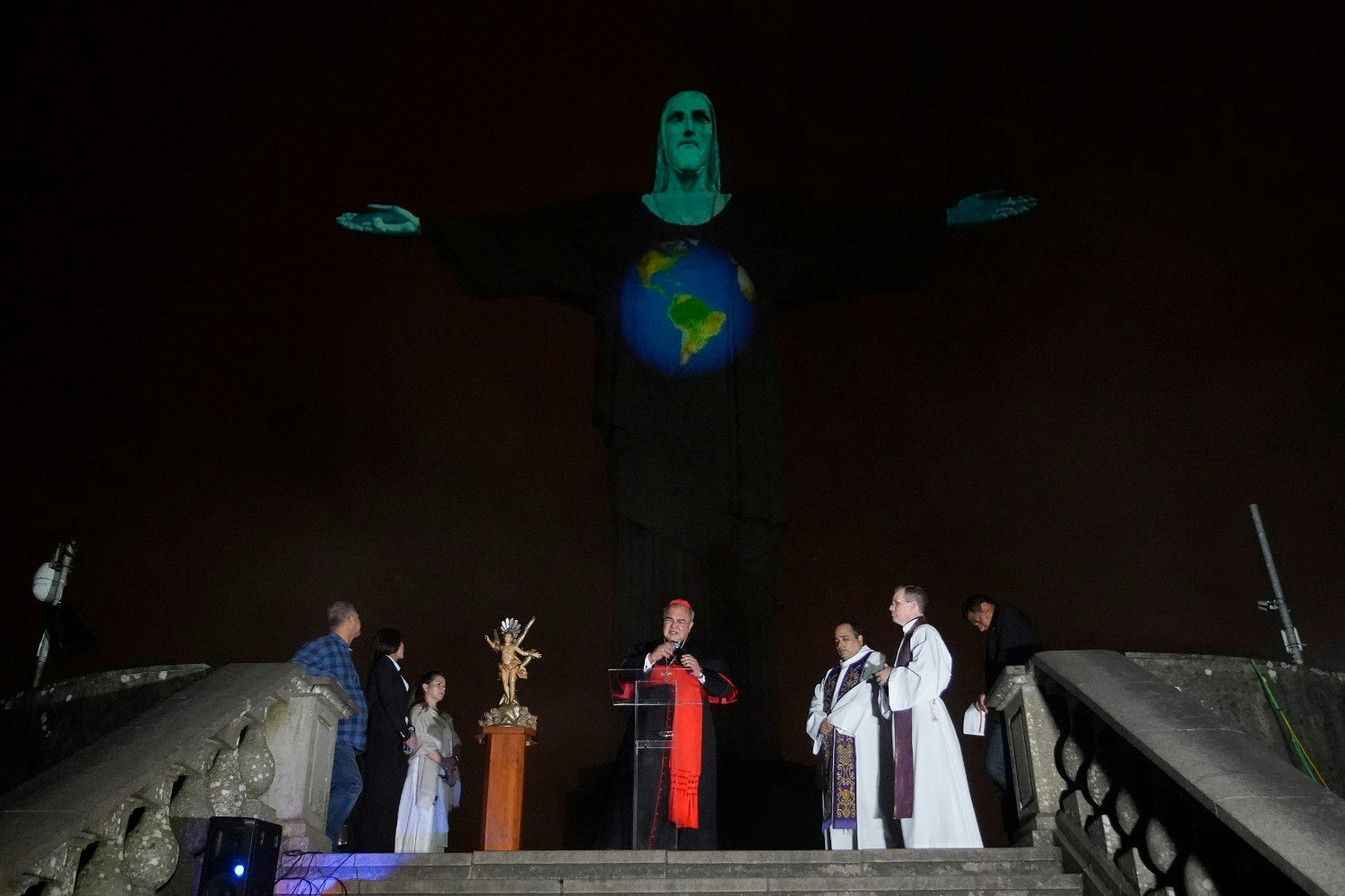Archbishop of Rio de Janeiro, Dom Orani Tempesta, performs a mass at the illuminated statue of Christ the Redeemer in Rio de Janeiro