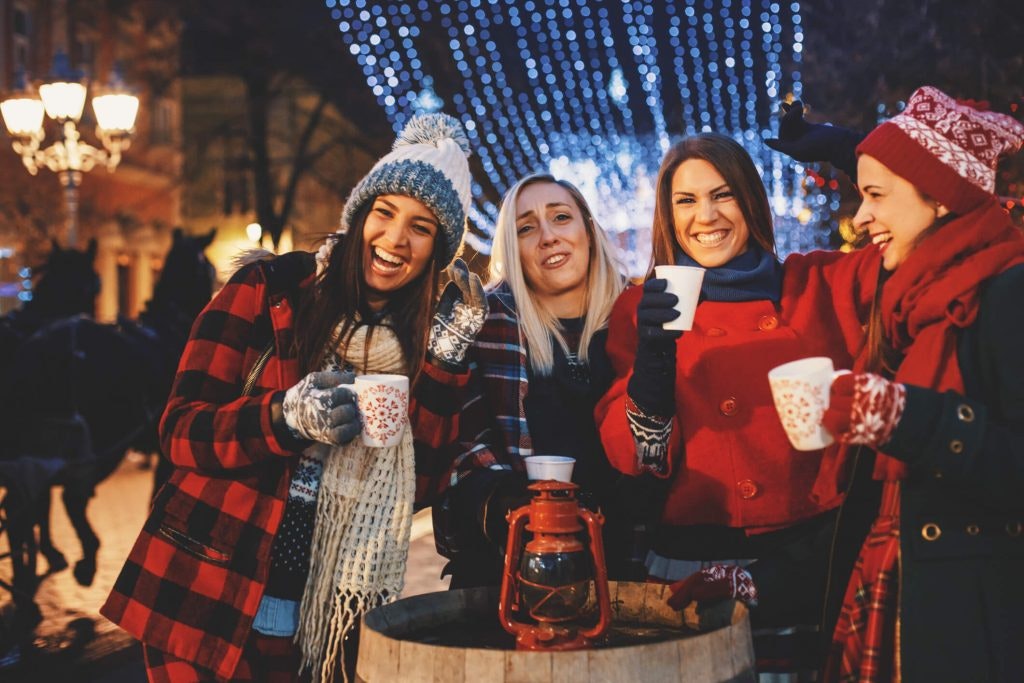 Friends toast at a Christmas market 