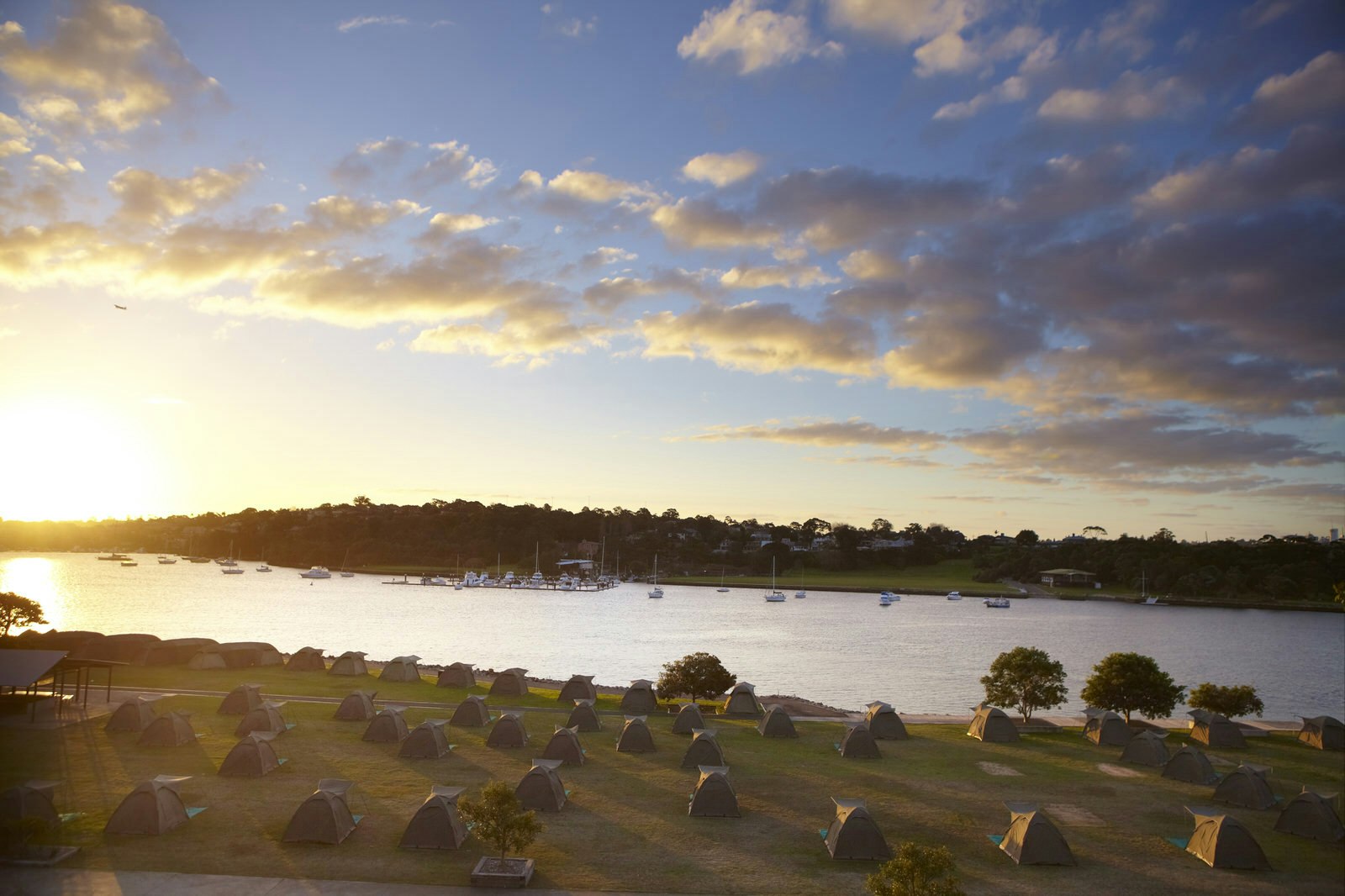 Campsite on Cockatoo Island overlooking harbour at sunset.