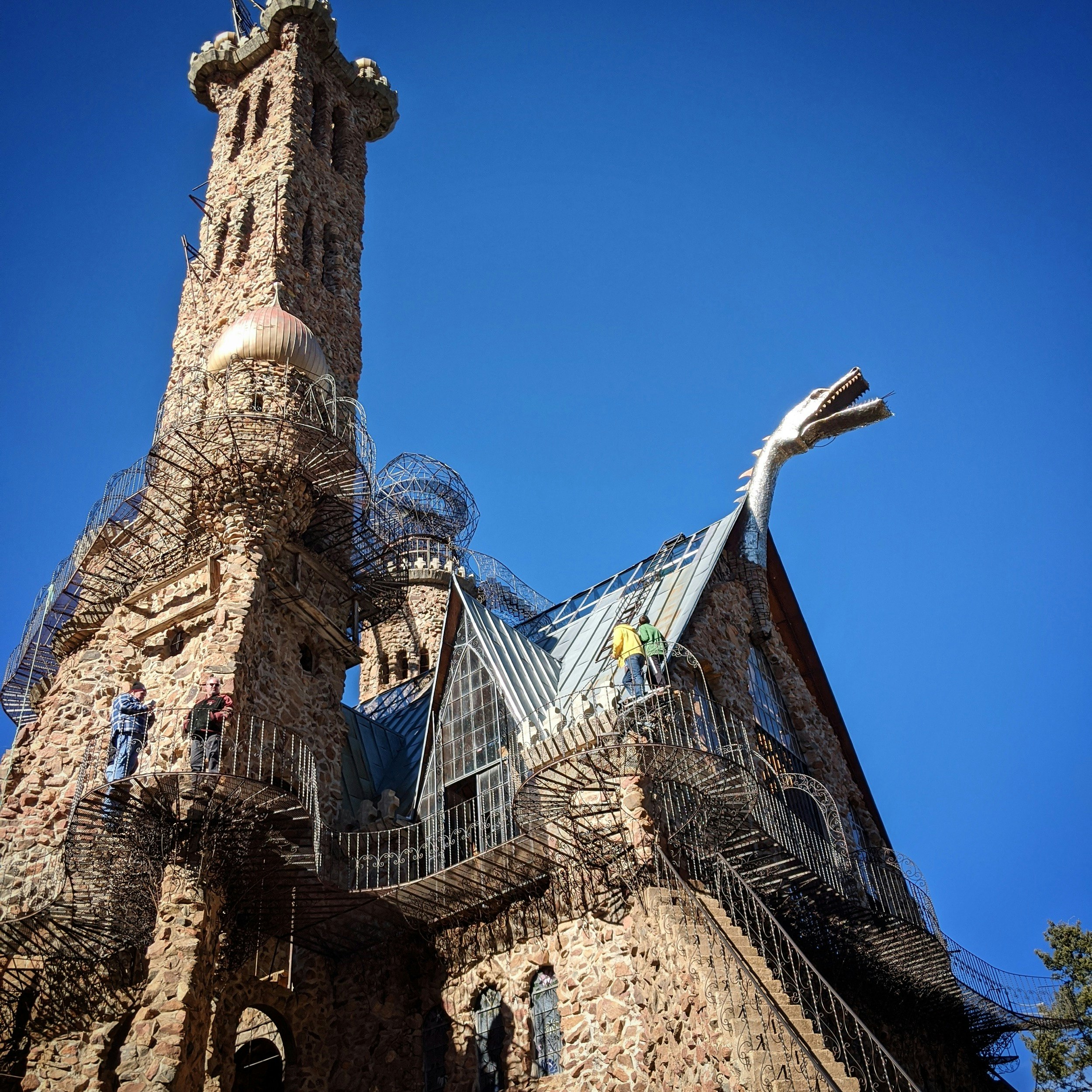 A dragon's head pokes from the gable of a roof at Bishop Castle in Colorado