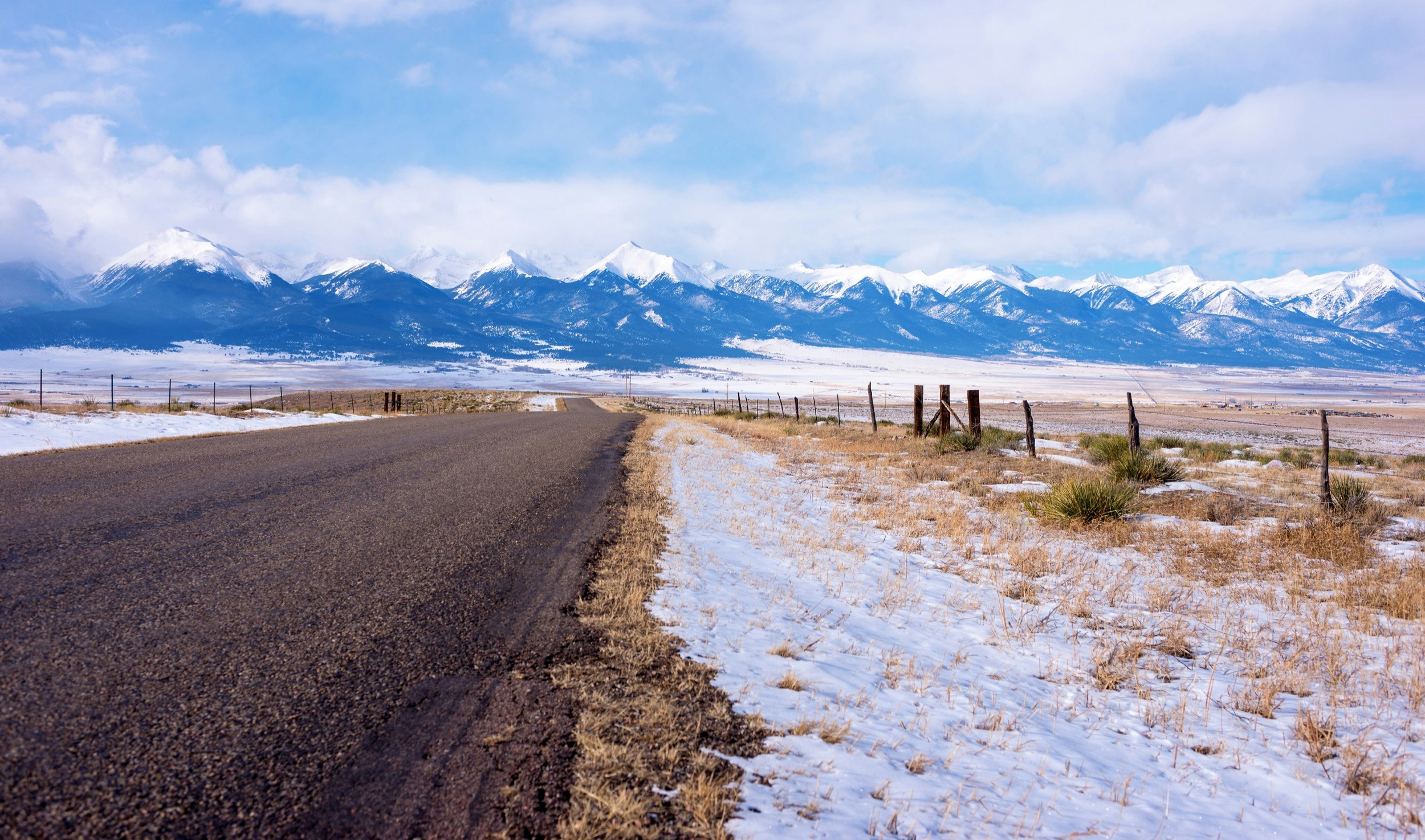 The Sangre De Cristo Mountains loom in the distance on the road from Westcliffe in Colorado