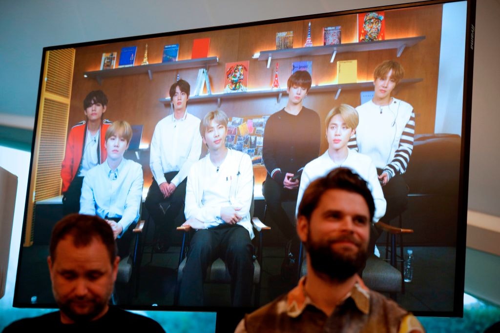 Danish artist Jakob Kudsk Steenson sits in front of a monitor live-streaming South Korean boyband 'BTS' 