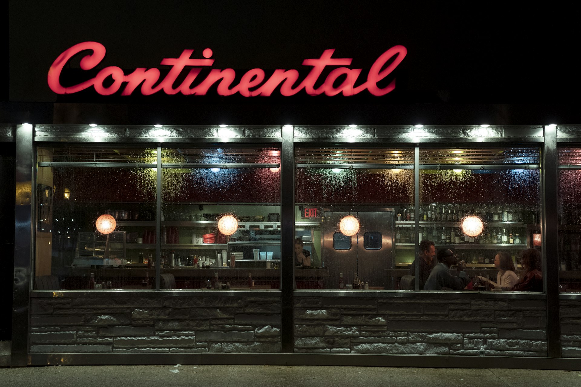 The outside of the Continental, in Philadelphia. The cast of AMC's Dispatches from Elsewhere are visible in the window