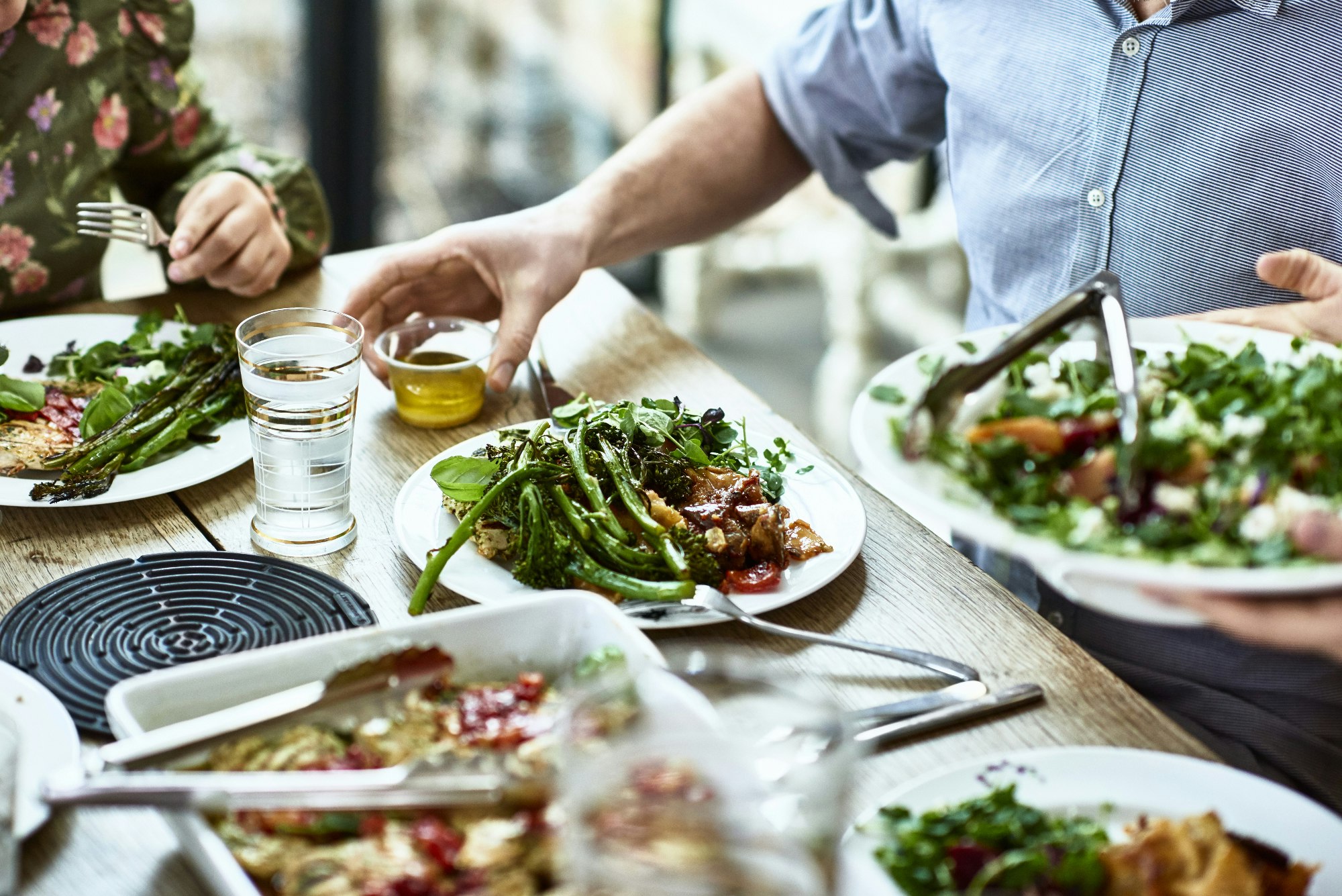 Cropped view of table laid with crockery and fresh homemade vegetarian food