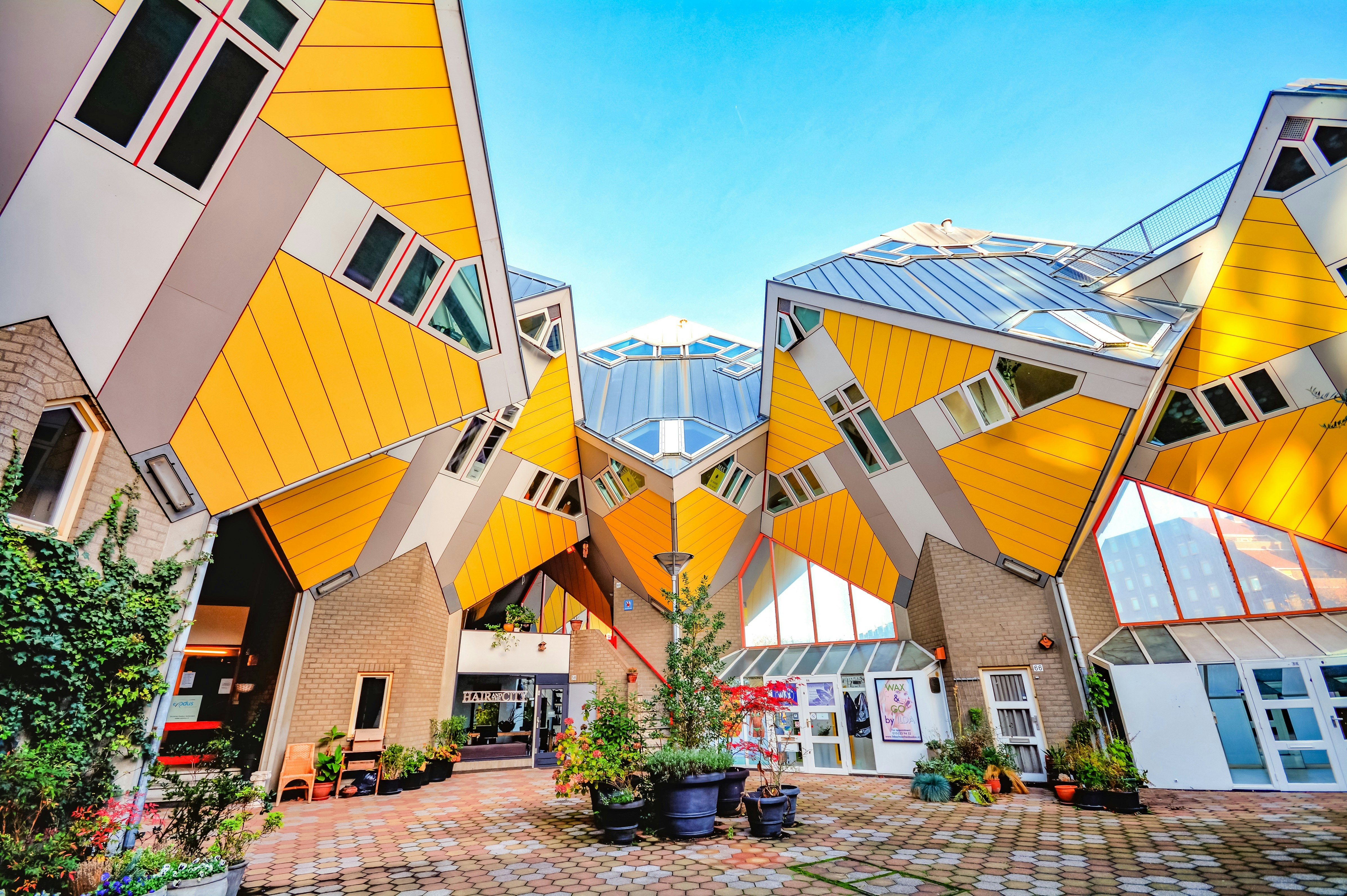 Rotterdam's Cube Houses, yellow and white homes that resemble cubes tiled at 45 degrees above the ground. 