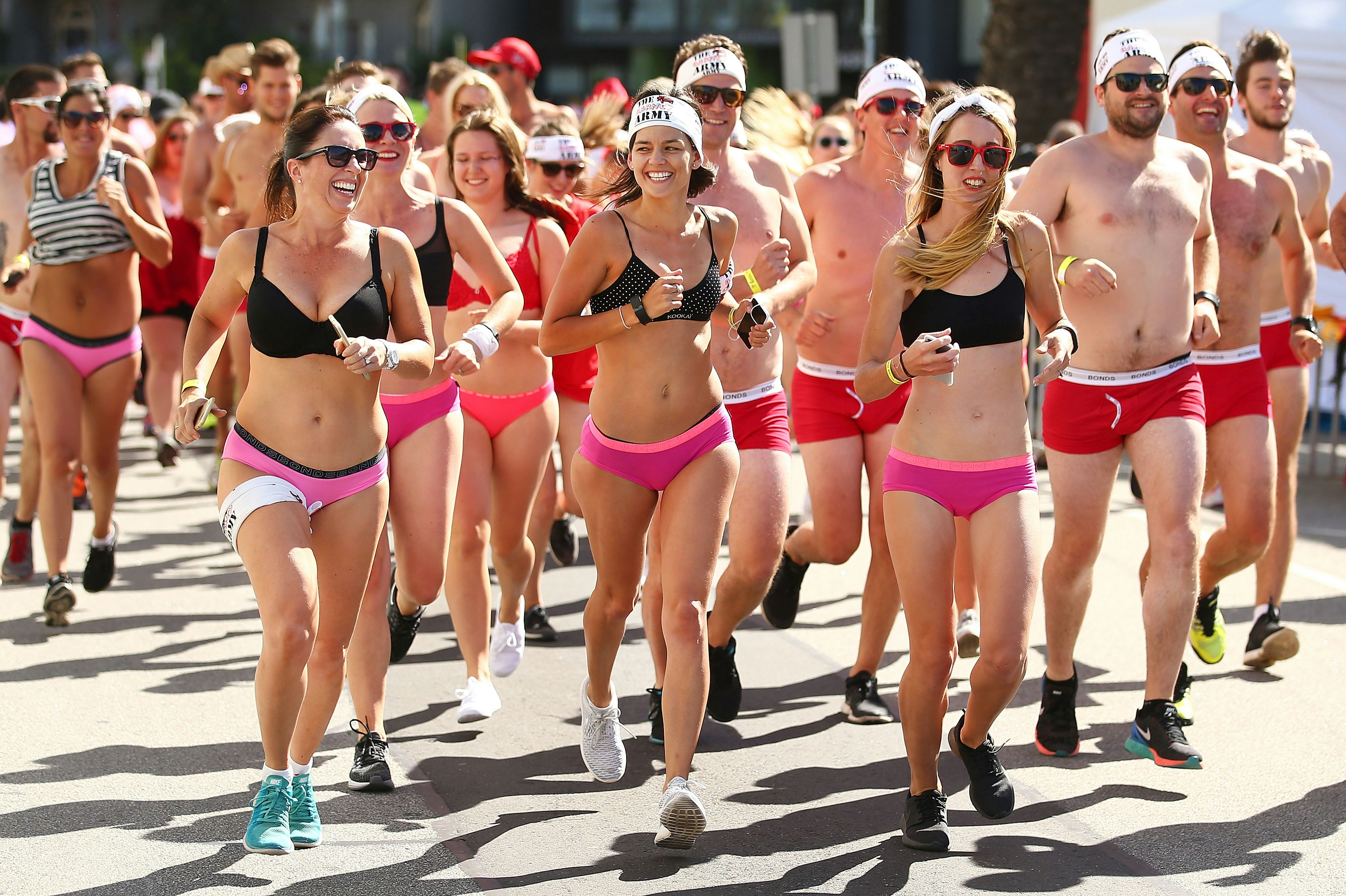 A group of people run down a street in their underwear in the Cupid's Undie Run