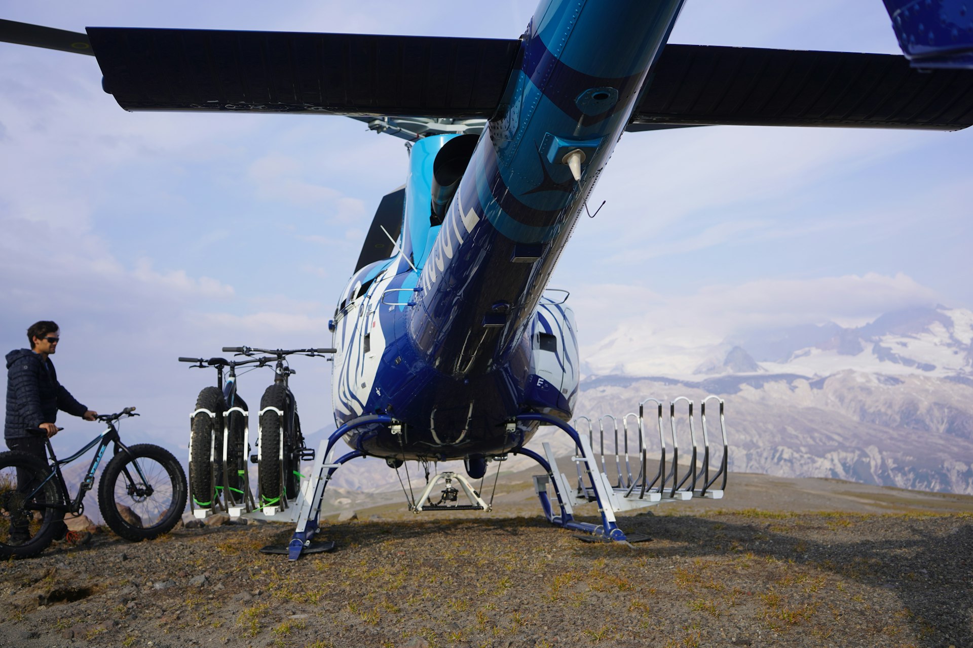 The rear of a helicopter with bike racks loaded with fat tire bikes
