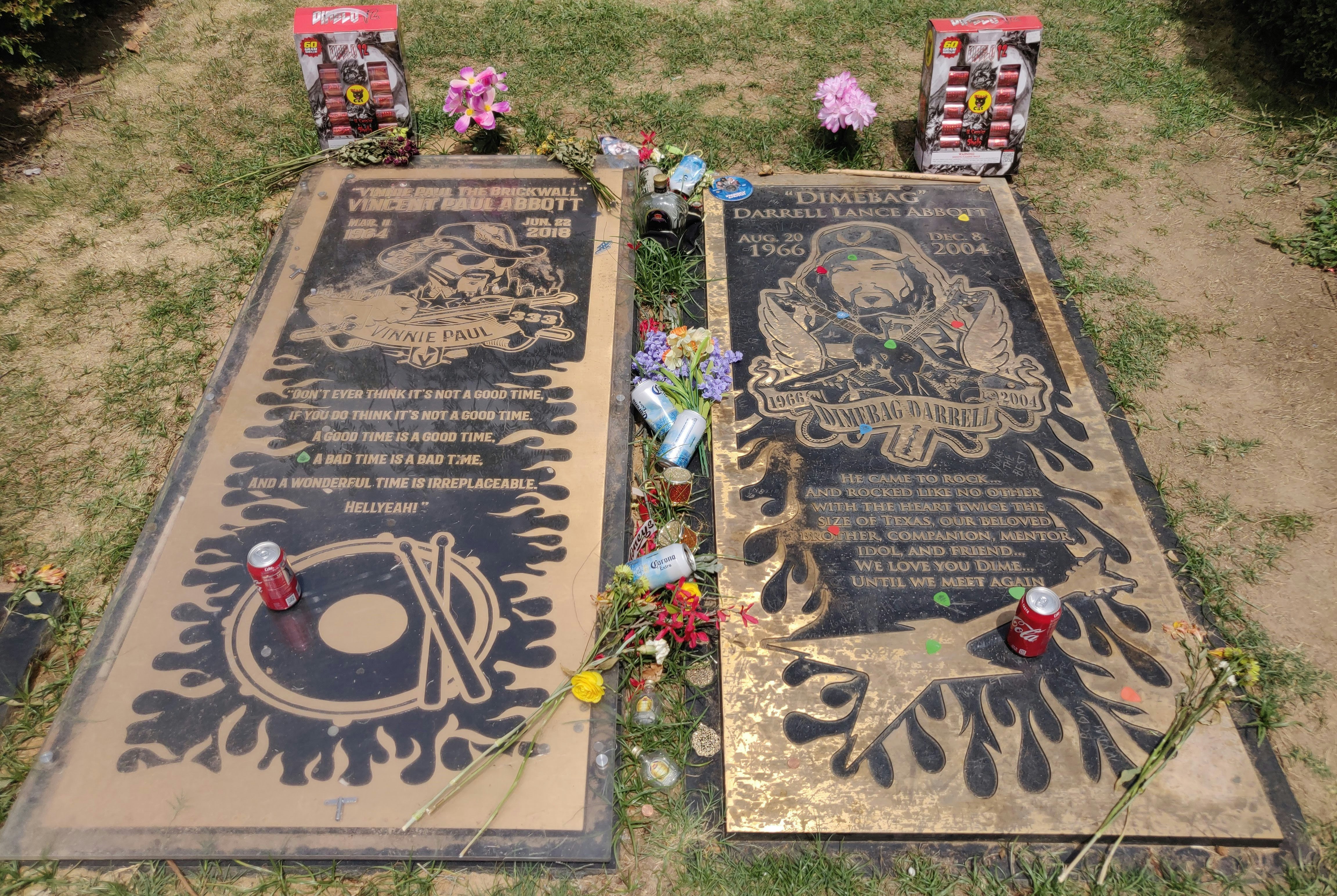 The graves of Darrell ‘Dimebag’ Abbott and his brother, Vinnie Paul, in Arlington, Texas. The two graves, which are large slabs laid into the grass side by side, are littered with beer cans and guitar picks.
