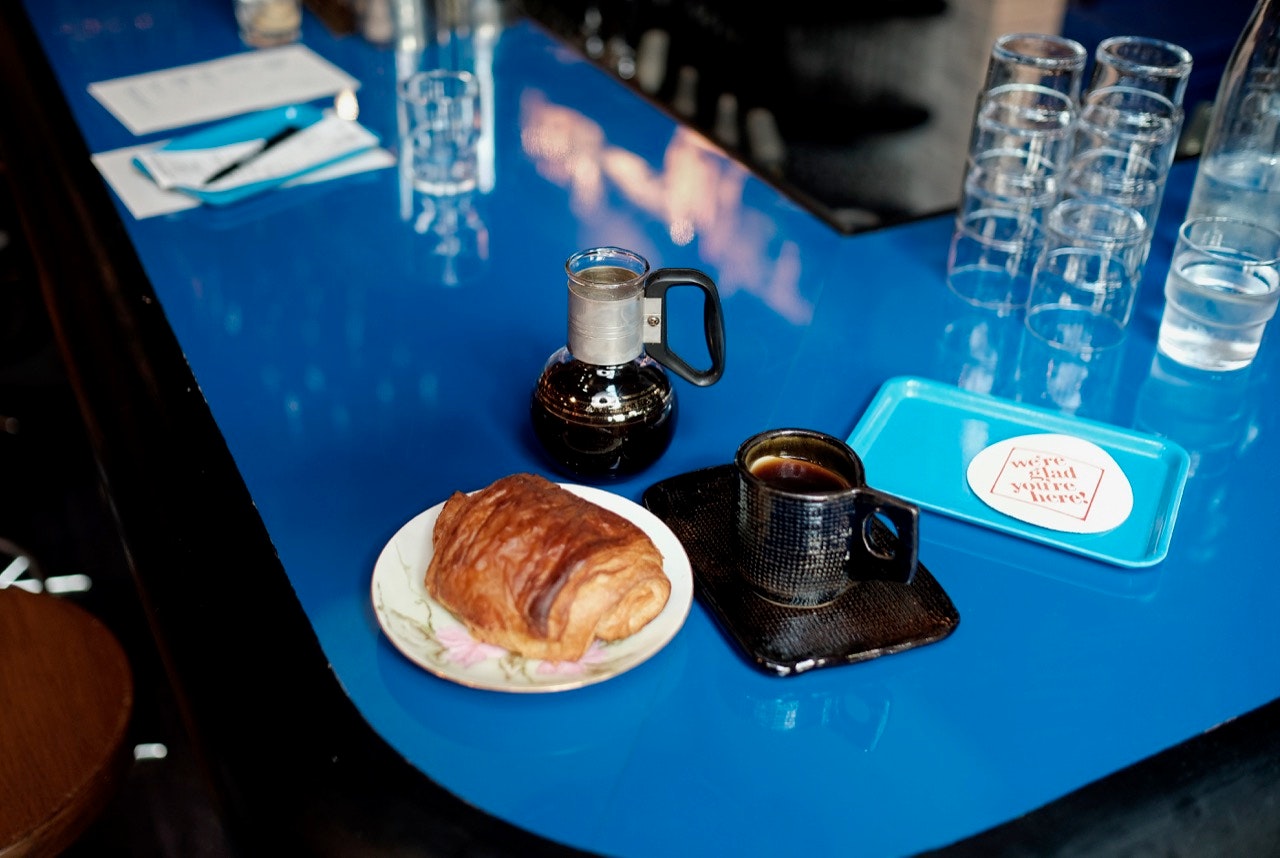 Corner counter seat at DayMoves with coffee and croissant