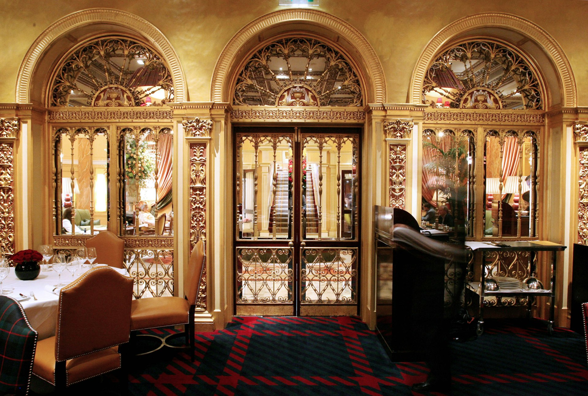 Three ornate gold and trellis doors, entrances to the Dorchester Grill in London