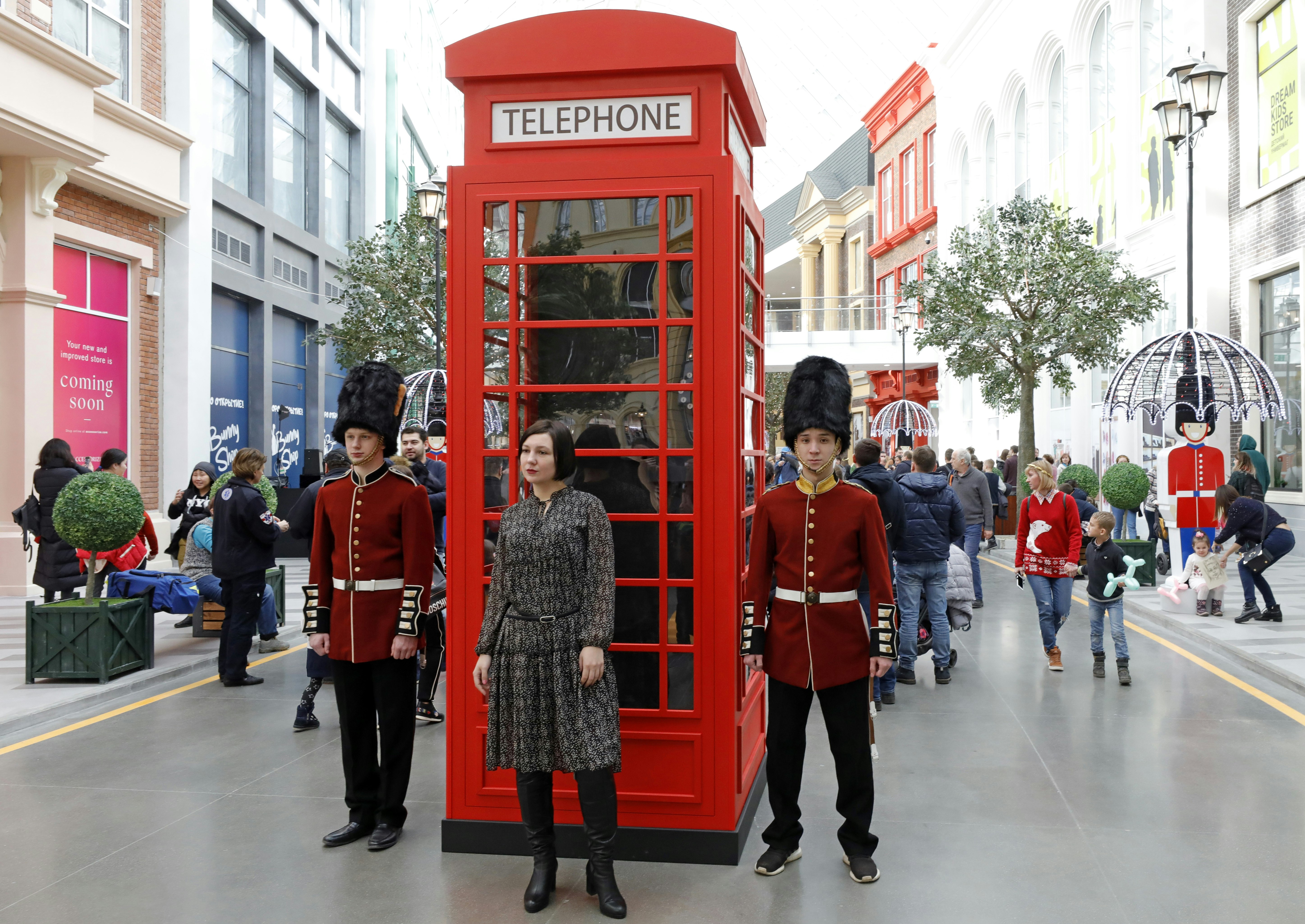 A traditional London phone box and royal guards at an indoor theme park