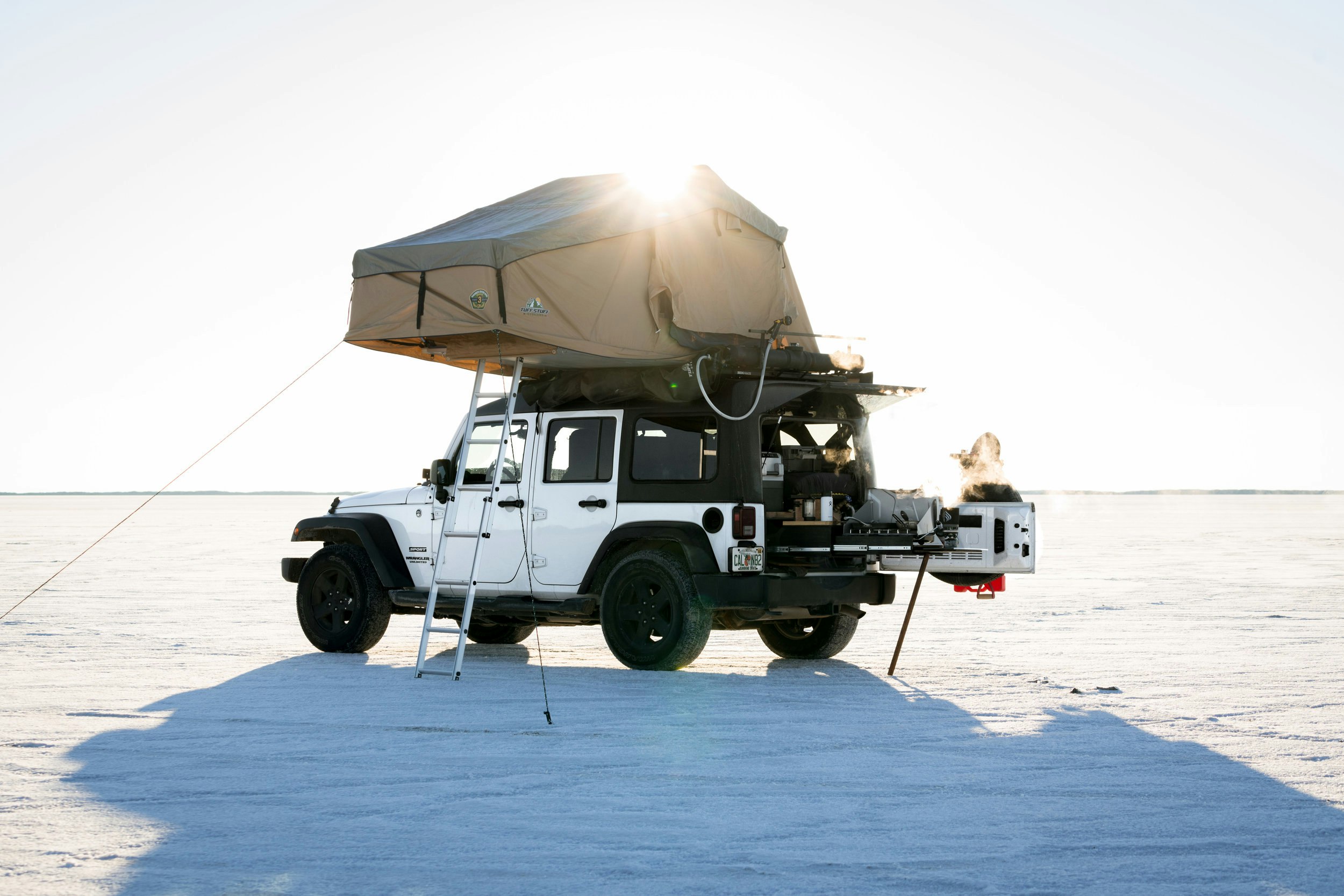 Drew's white Jeep Wrangler set up in a desert