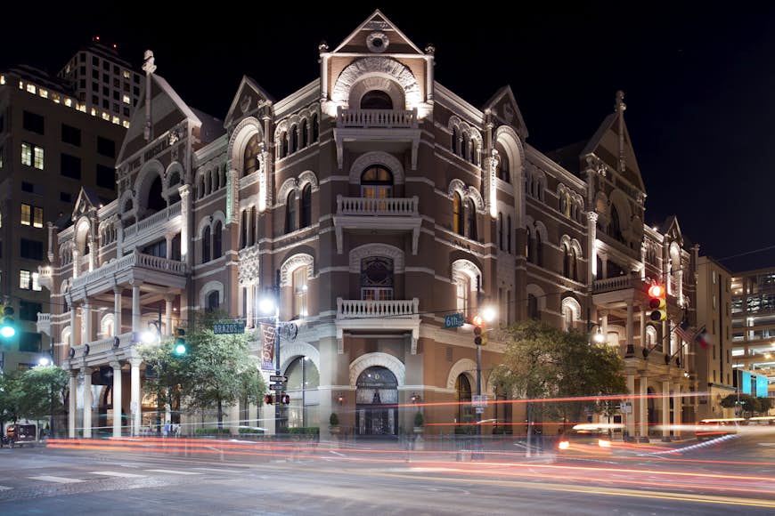 Outside shot of the Driskill hotel at night; Norman vs. Austin