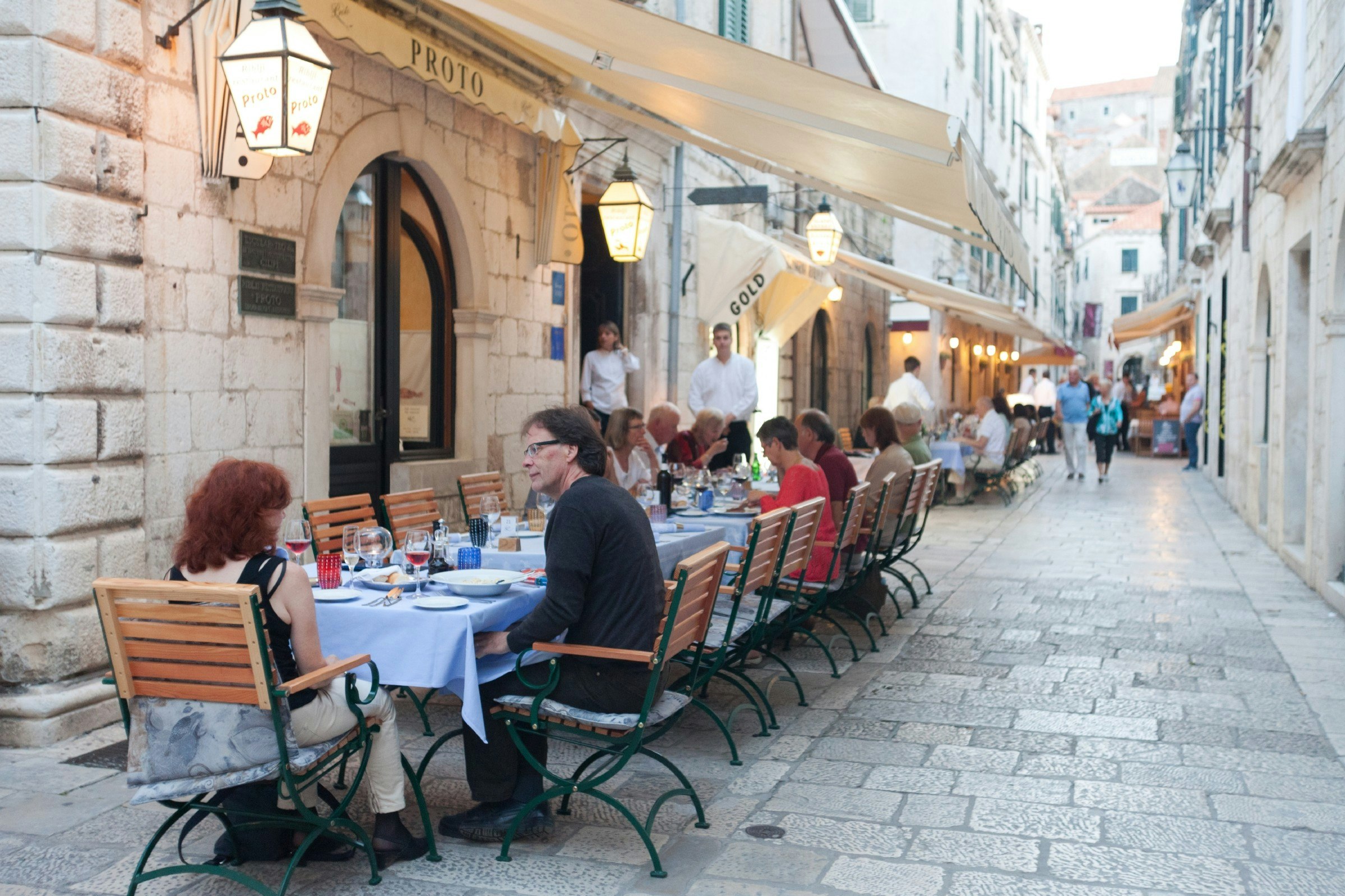 People sitting outside a Dubrovnik restaurant