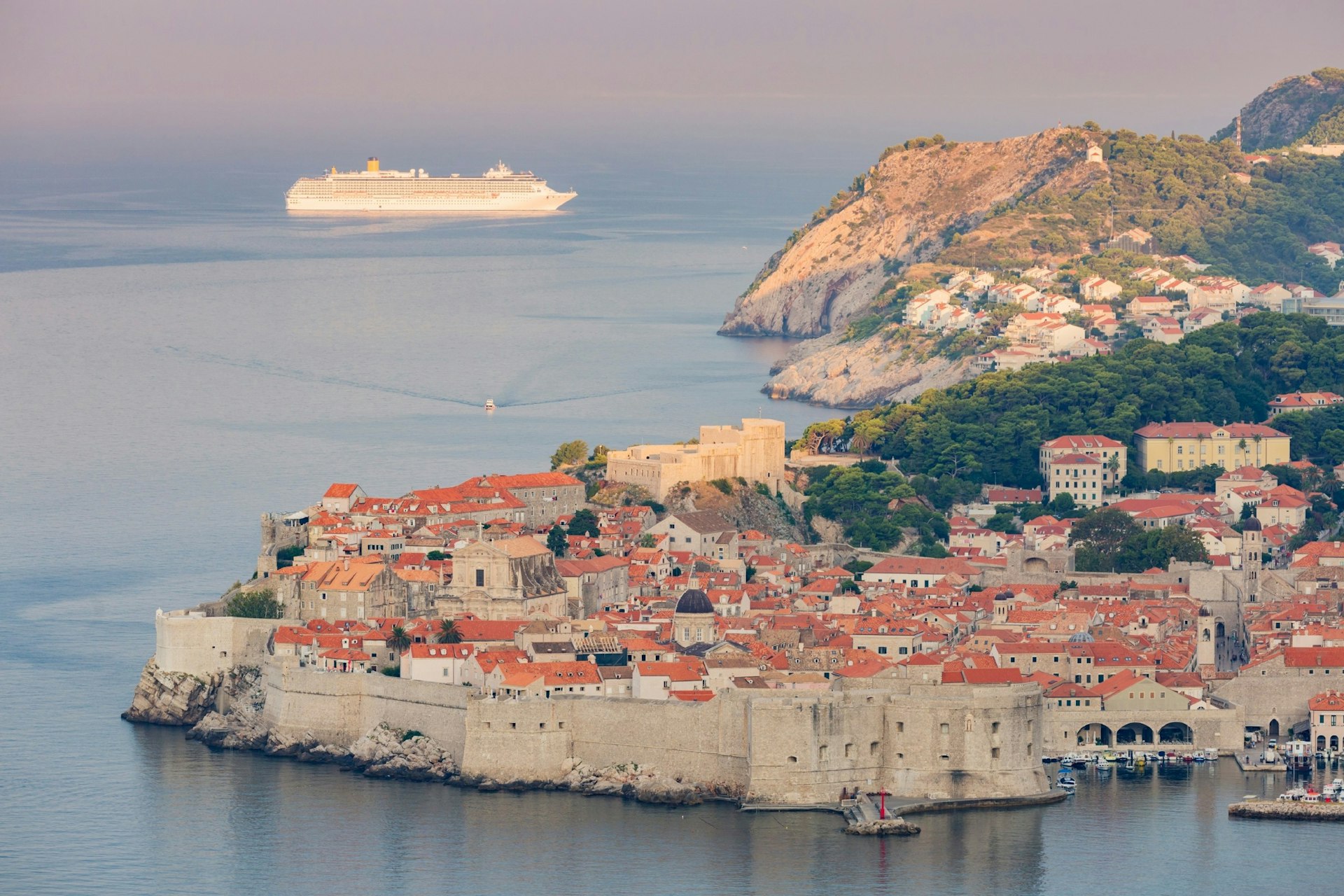 A cruise ship passing behind the waterfront of Dubrovnik